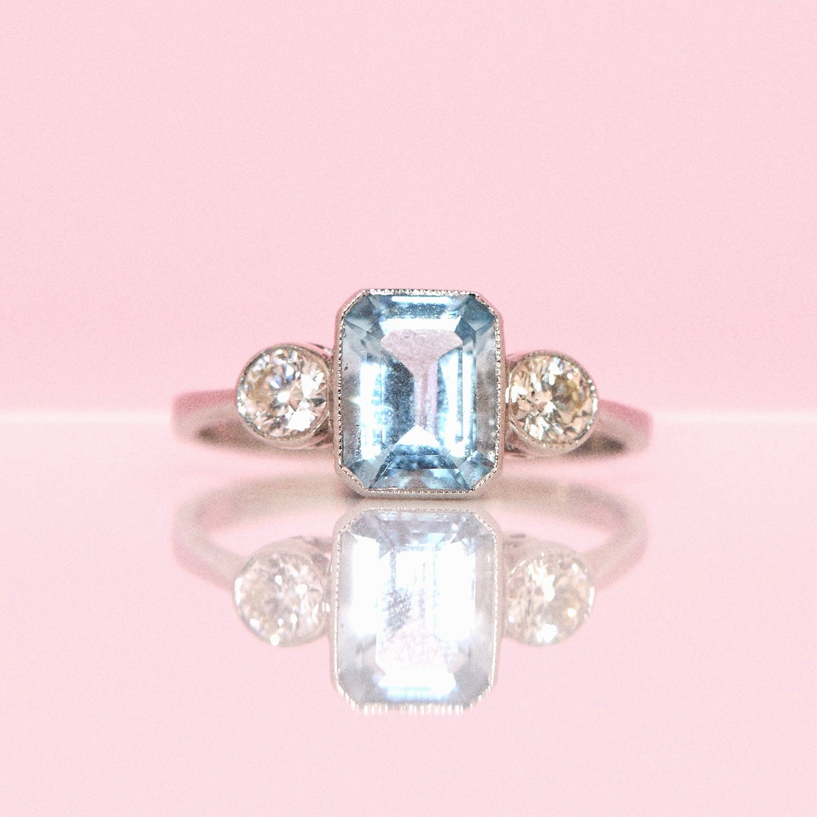 Platinum 1.40ct emerald cut aquamarine and diamond three stone ring