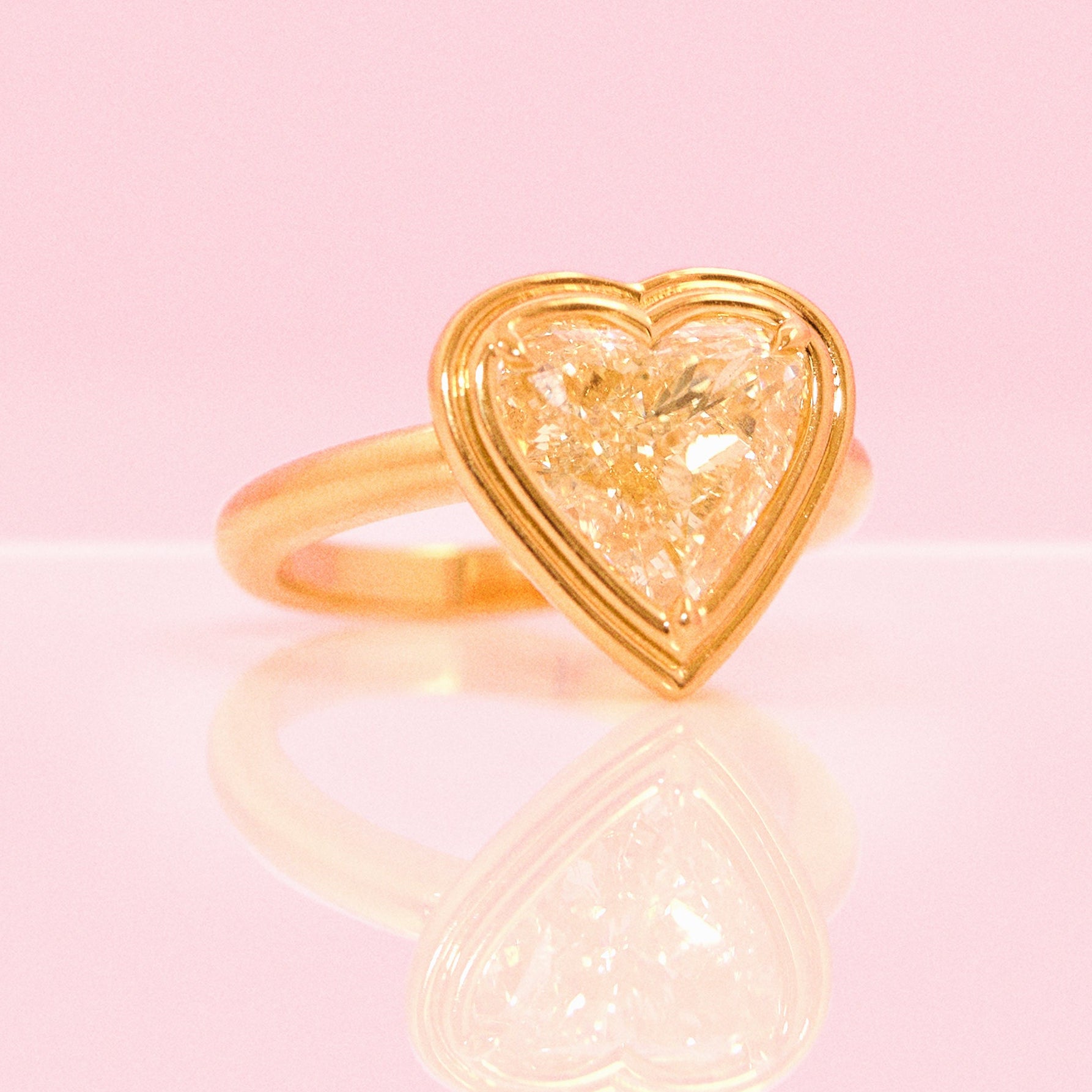 18ct gold bezel set fancy yellow 2.35ct heart-shaped diamond ring