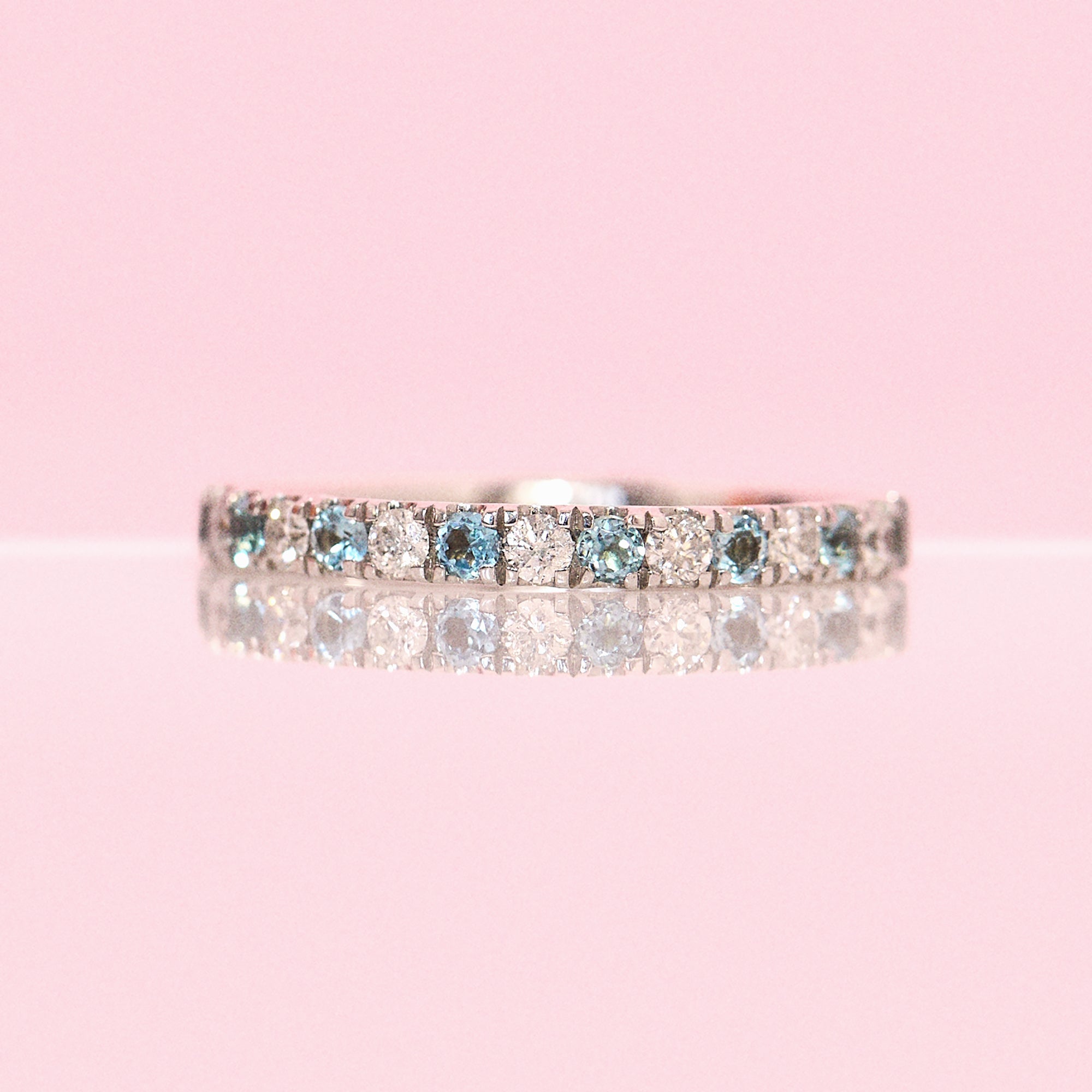 9ct gold 0.30ct blue topaz and 0.21ct diamond half-eternity ring