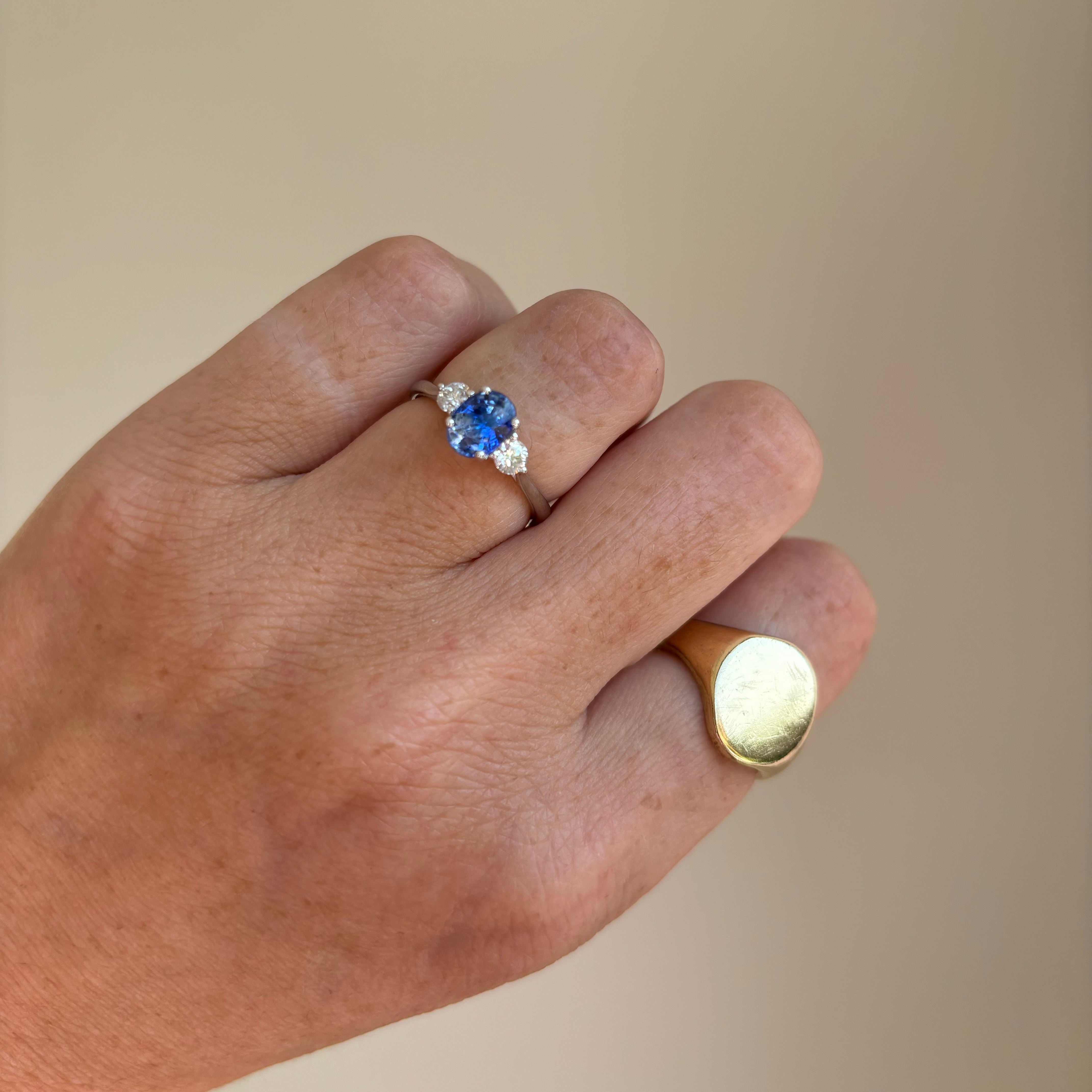 Platinum blue sapphire and diamond three stone ring