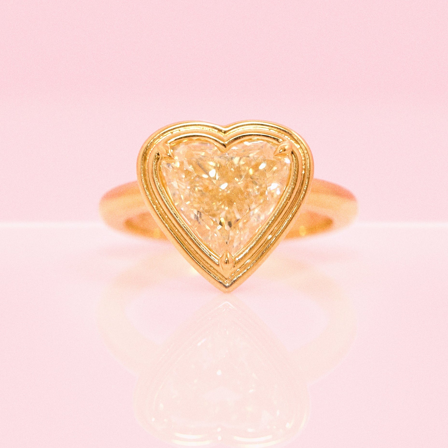 18ct gold bezel set fancy yellow 2.35ct heart-shaped diamond ring