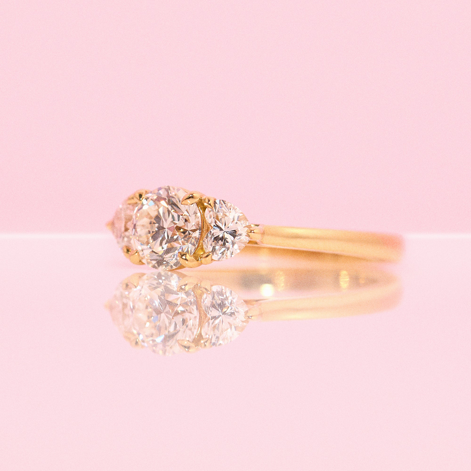 18ct gold ‘Hidden Hearts’ ring with a 0.90ct round shaped diamond centre stone and two heart shaped diamonds