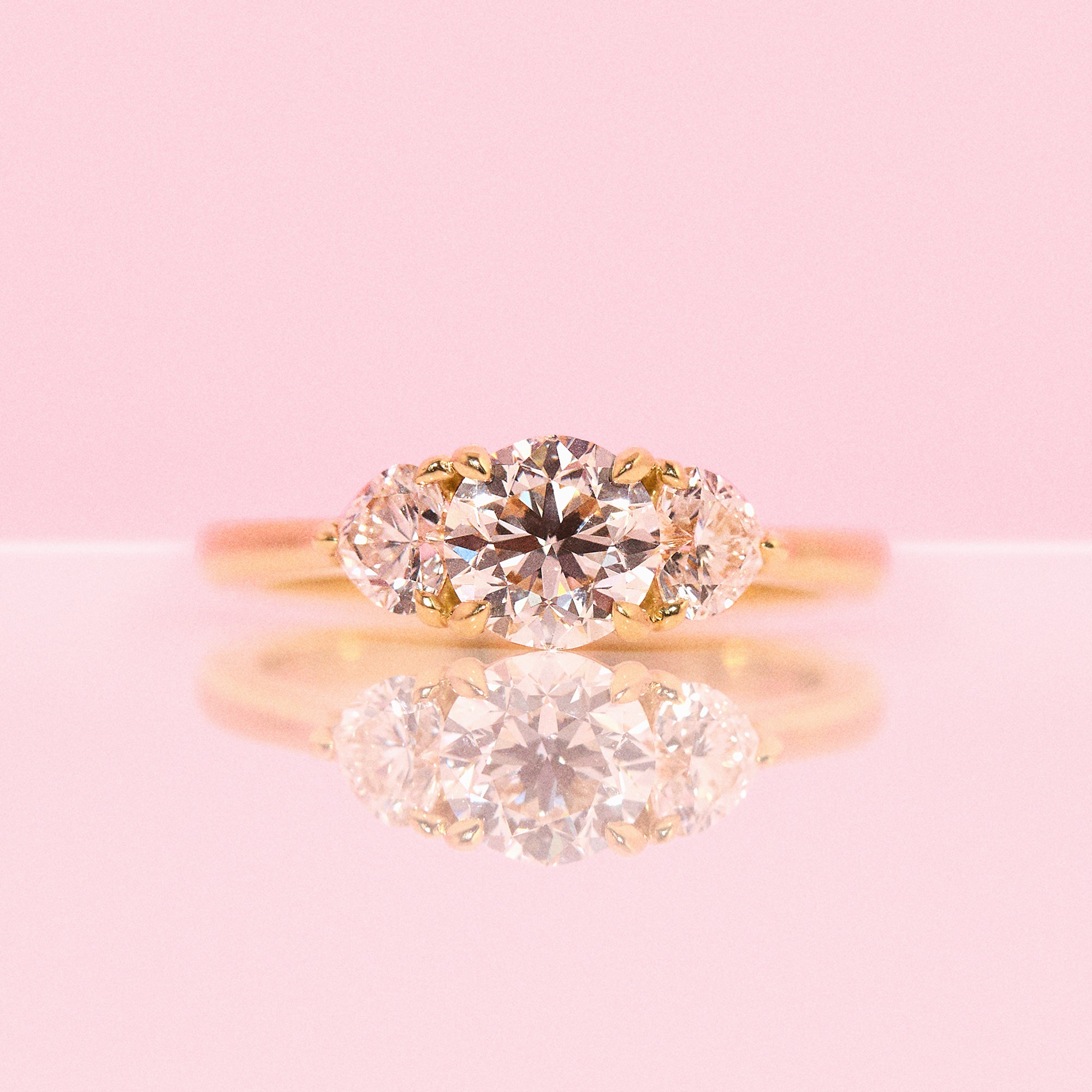 18ct gold ‘Hidden Hearts’ ring with a 0.90ct round shaped diamond centre stone and two heart shaped diamonds