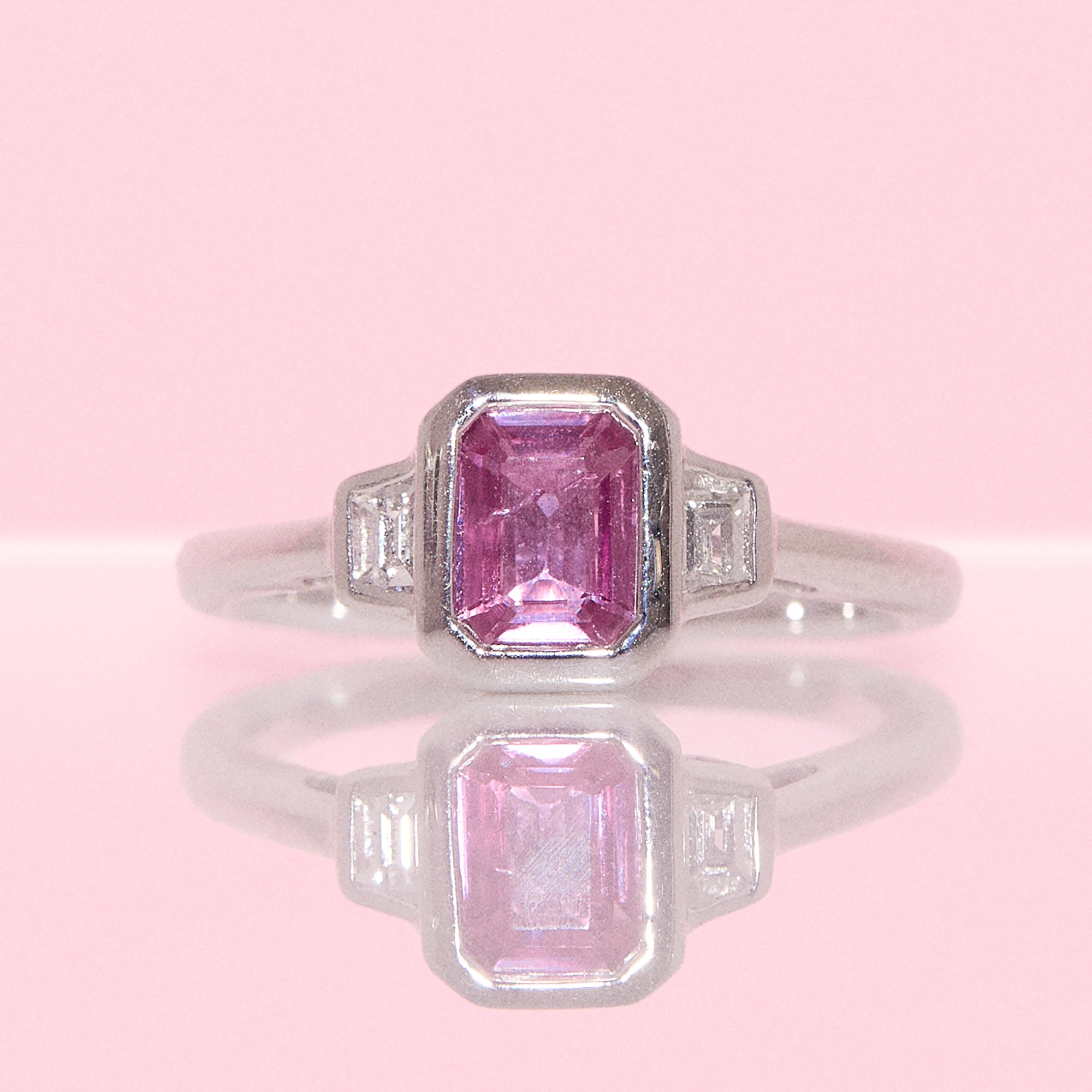 Platinum 0.95ct emerald cut pink sapphire and diamond bezel set ring