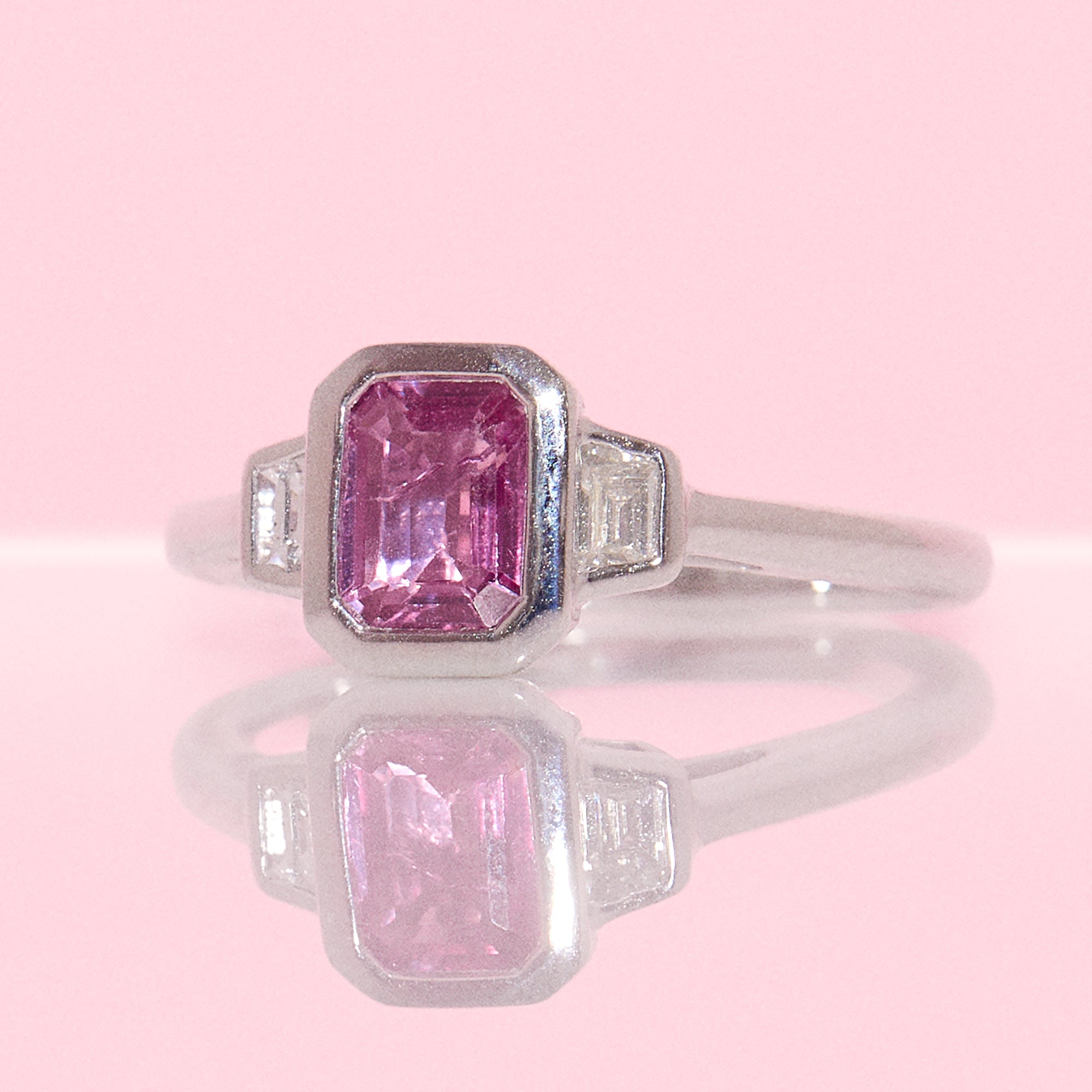 Platinum 0.95ct emerald cut pink sapphire and diamond bezel set ring