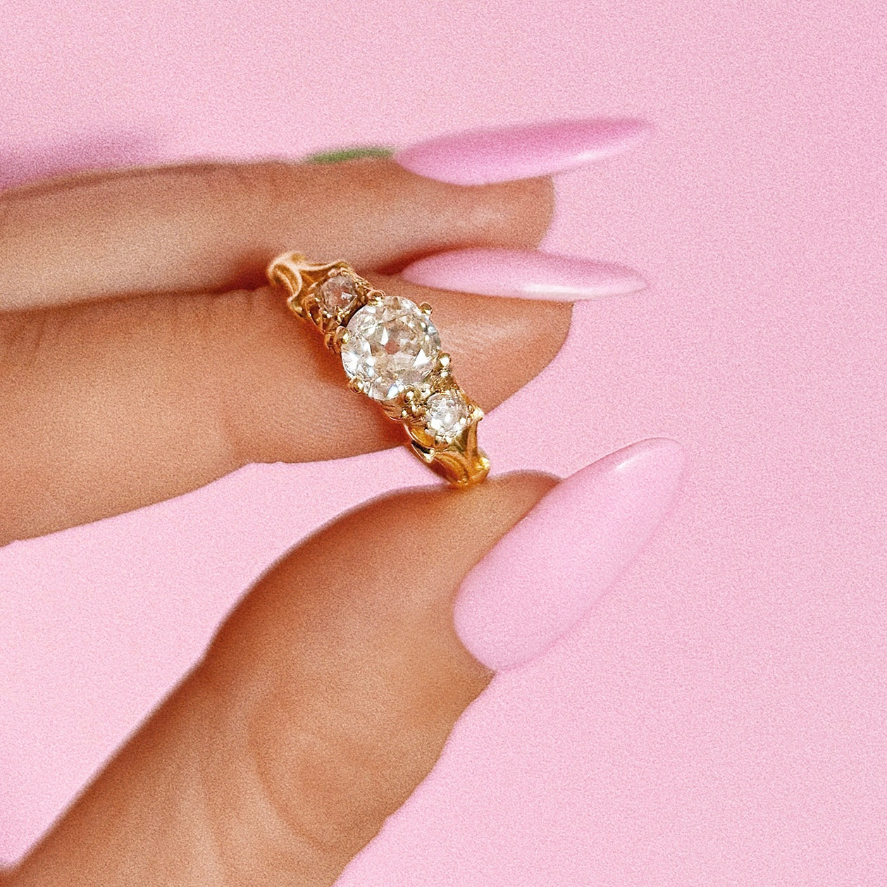 18ct gold old cut diamond three stone ring with carved shoulders