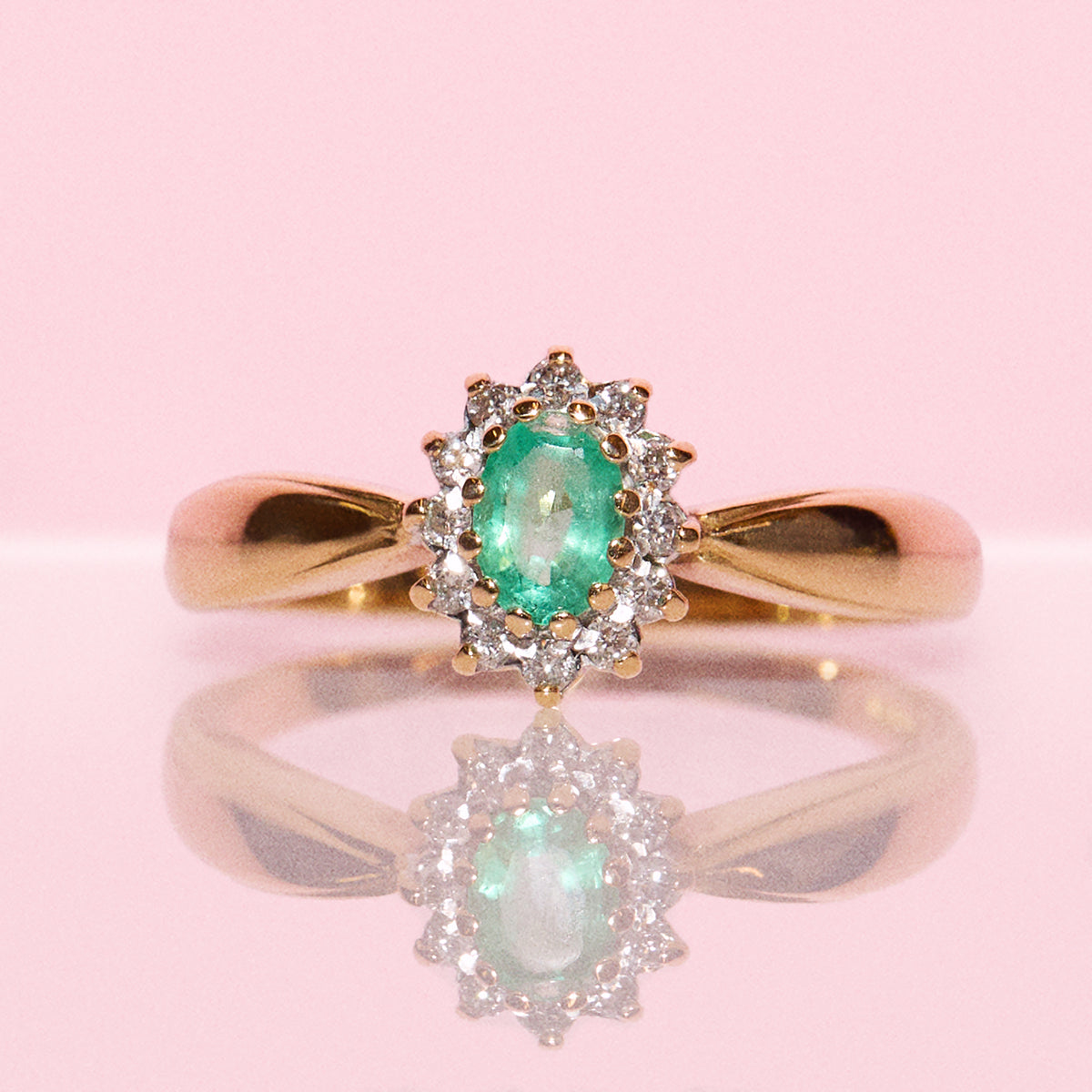 Vintage 18ct gold emerald and diamond cluster ring with a graduated band