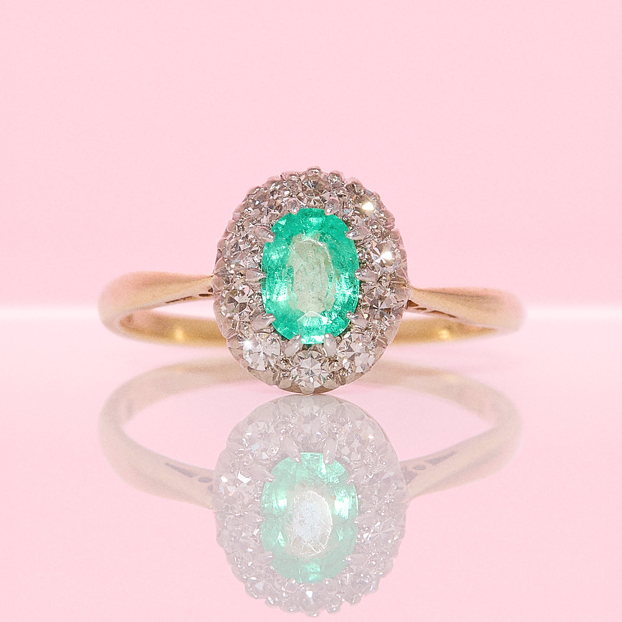 18ct gold oval emerald and diamond cluster ring