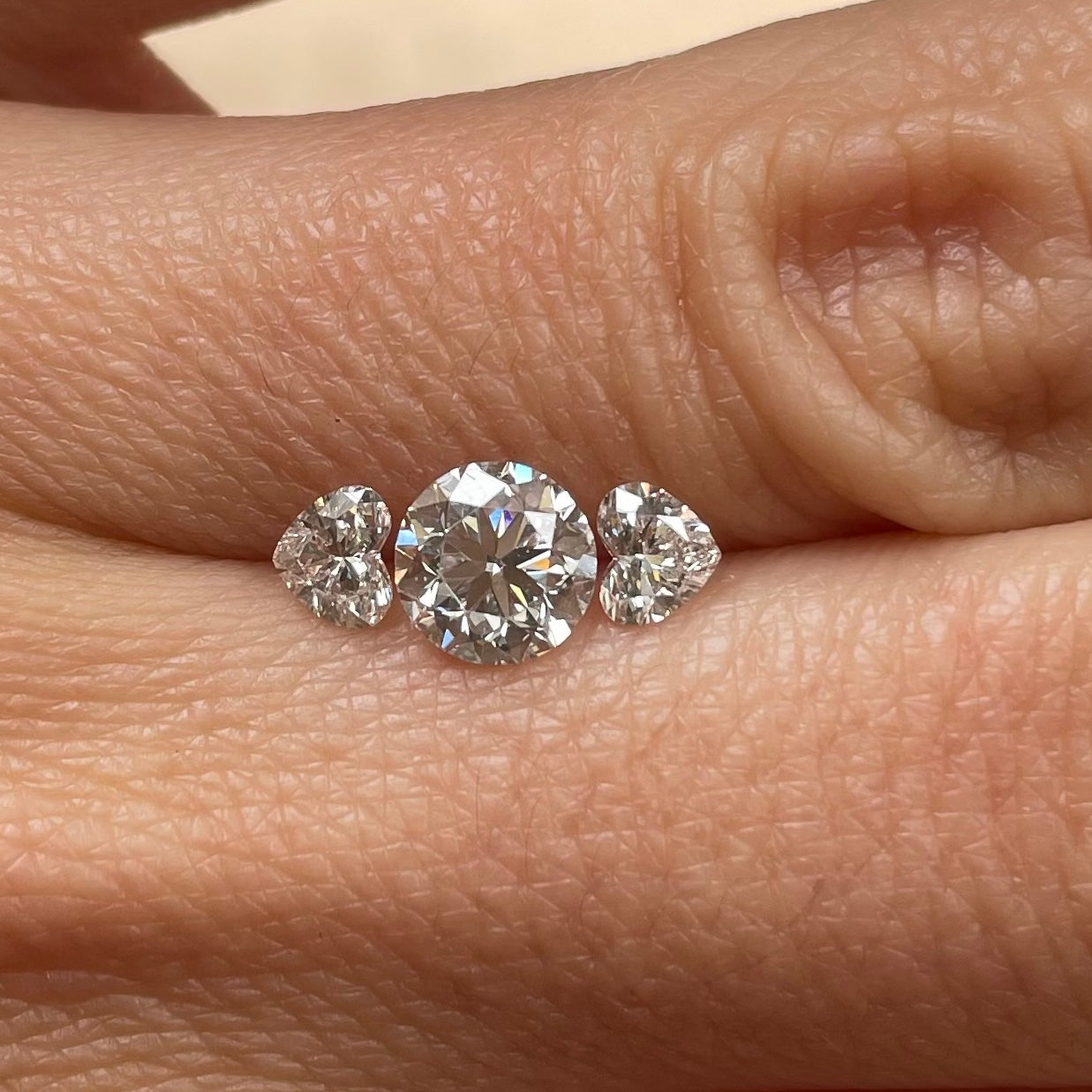 18ct gold 0.90ct round cut centre and two heart shaped diamond ‘Hidden Hearts’ ring