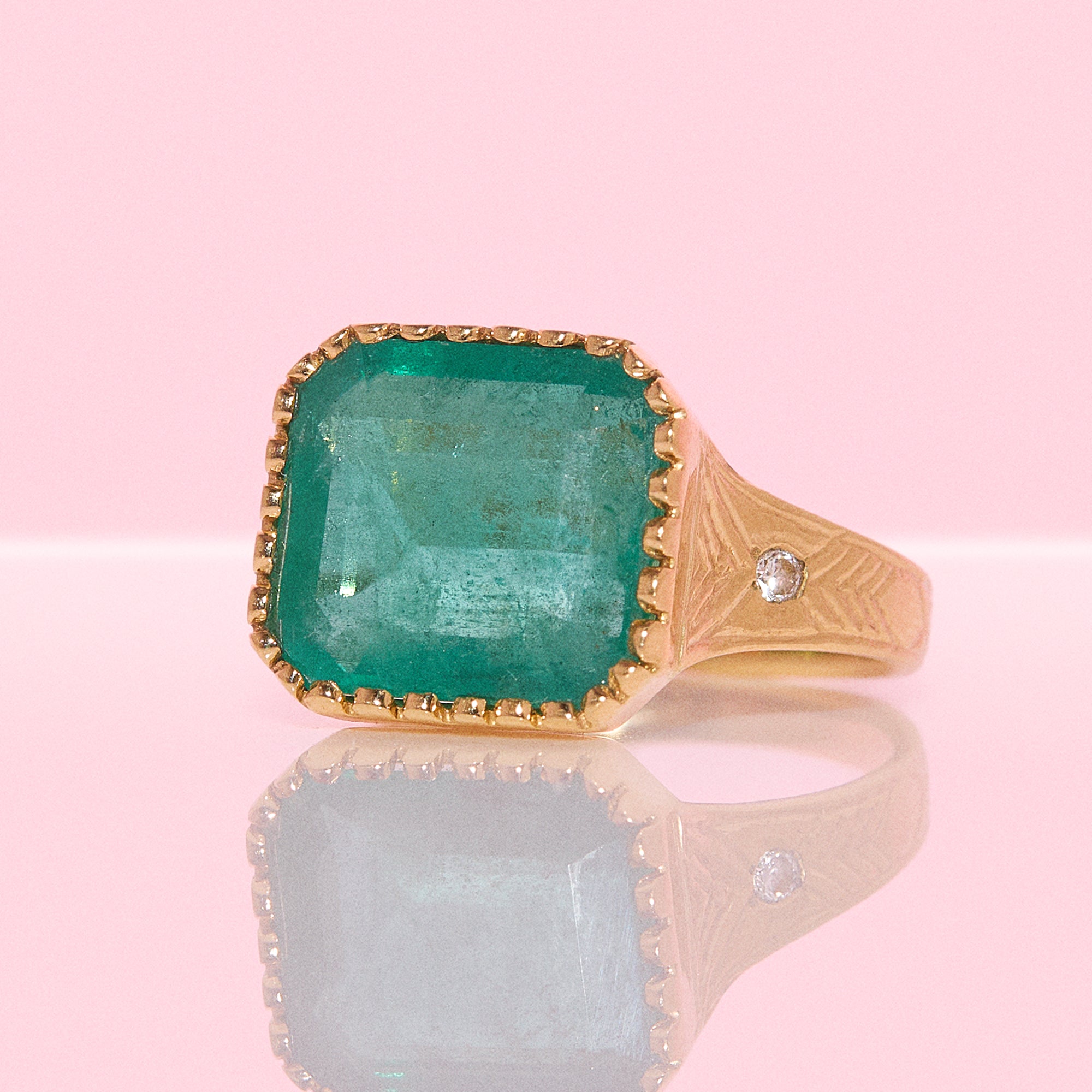 14ct gold 10.80ct Asscher cut emerald and diamond ring with engraved shoulders