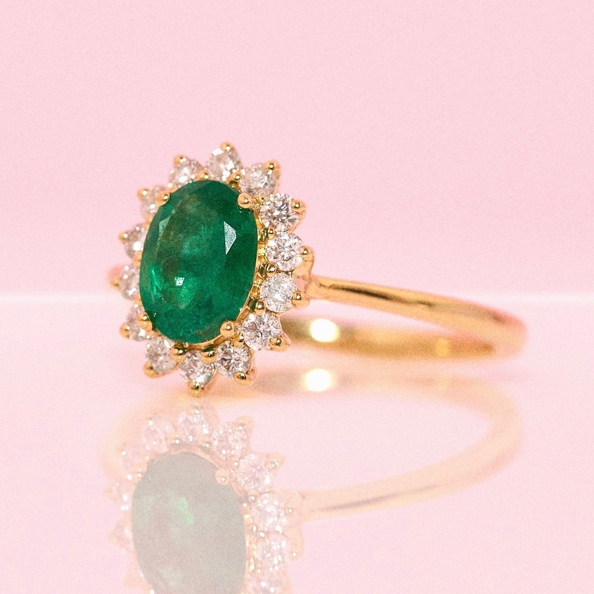 9ct gold 1.10ct oval emerald and 0.32ct diamond cluster ring