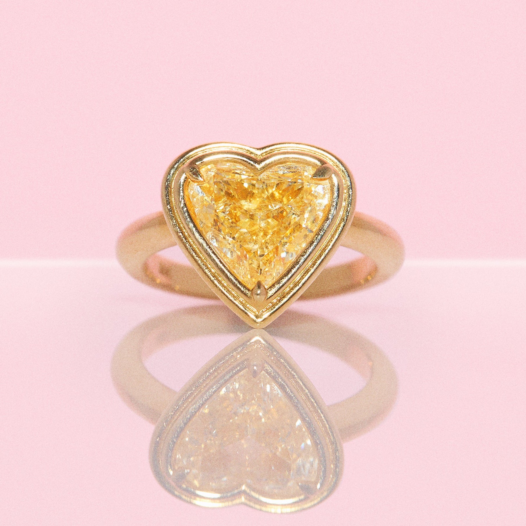 18ct gold bezel set fancy yellow 2.35ct heart-shaped diamond ring