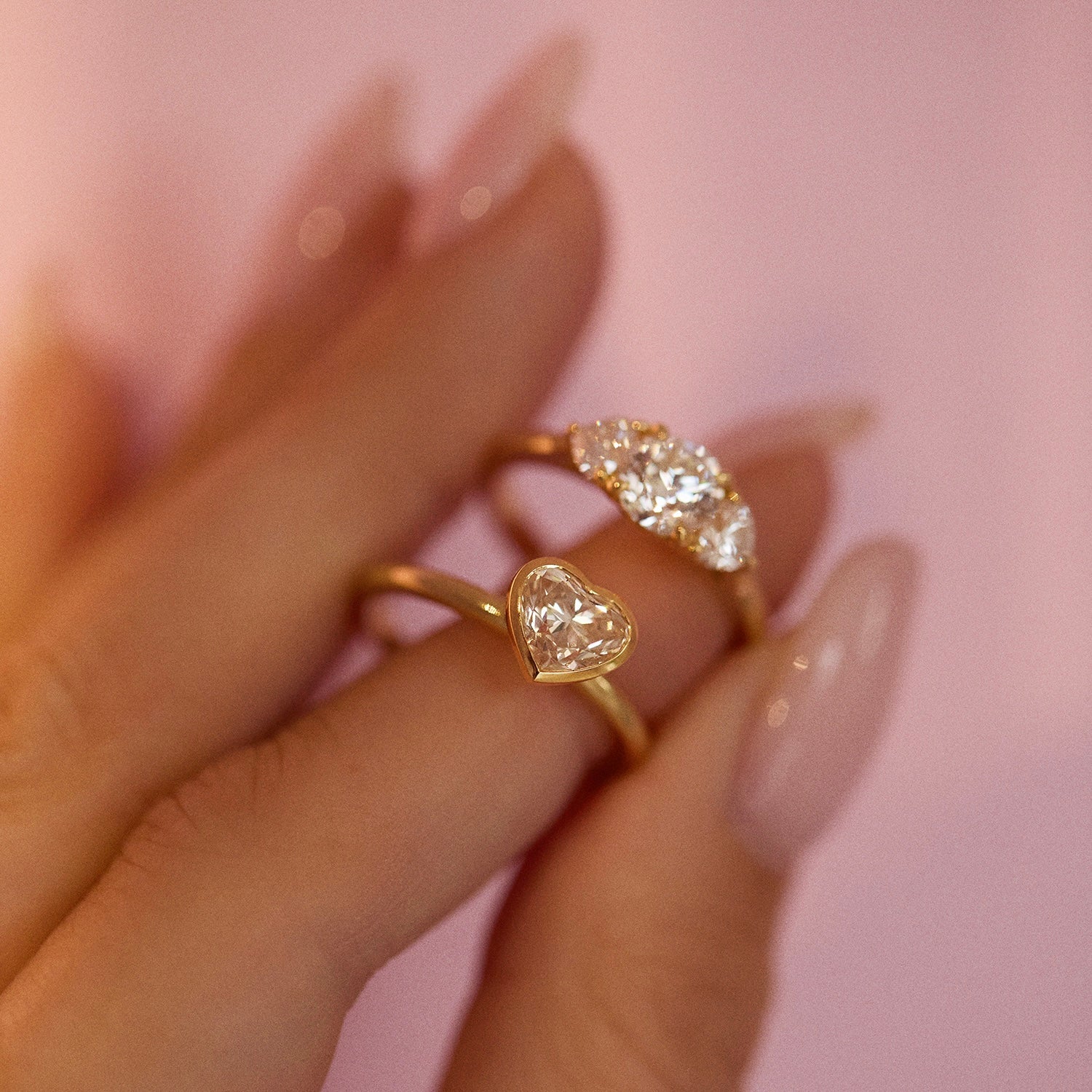 18ct gold ‘Hidden Hearts’ ring with a 0.90ct round shaped diamond centre stone and two heart shaped diamonds