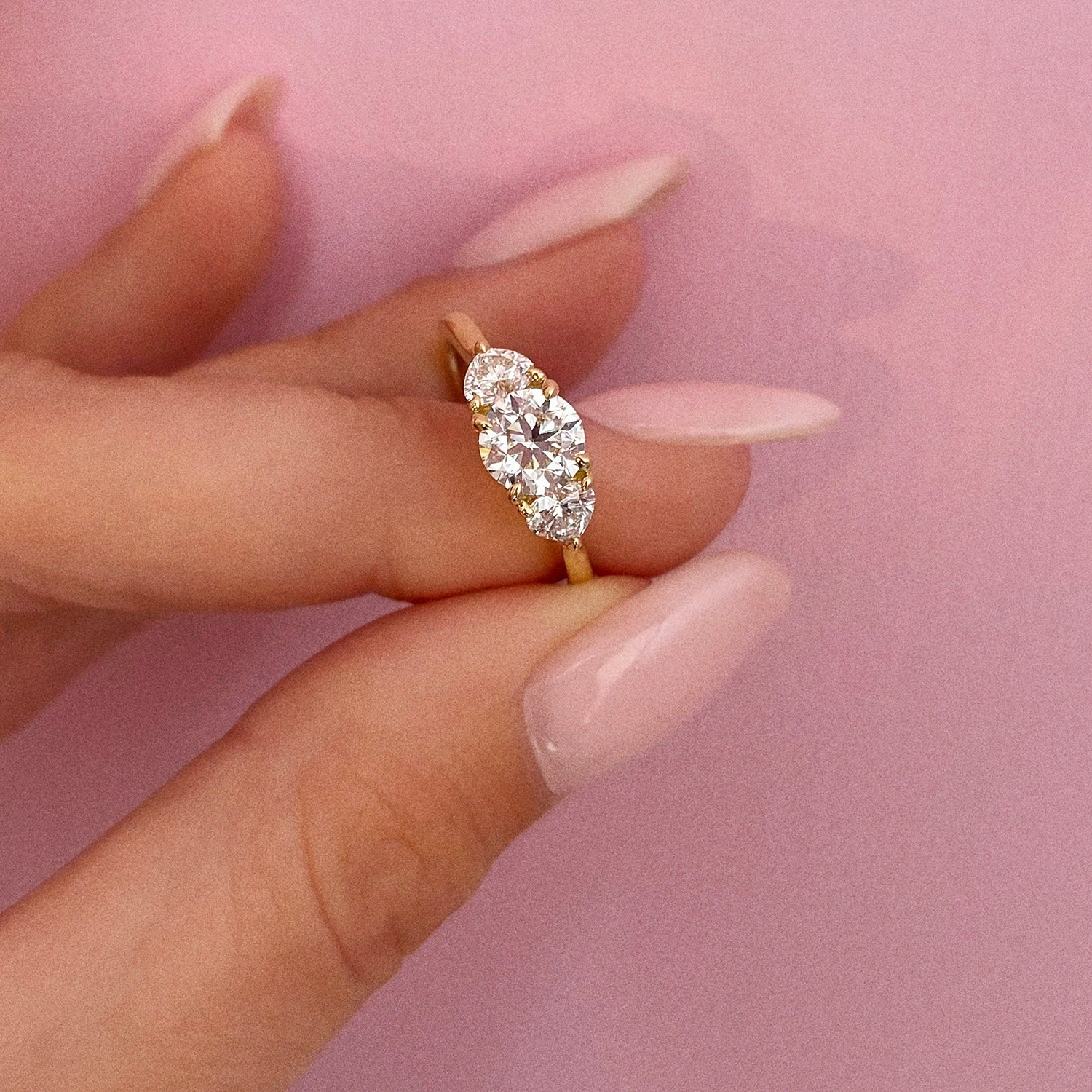 18ct gold ‘Hidden Hearts’ ring with a 0.90ct round shaped diamond centre stone and two heart shaped diamonds