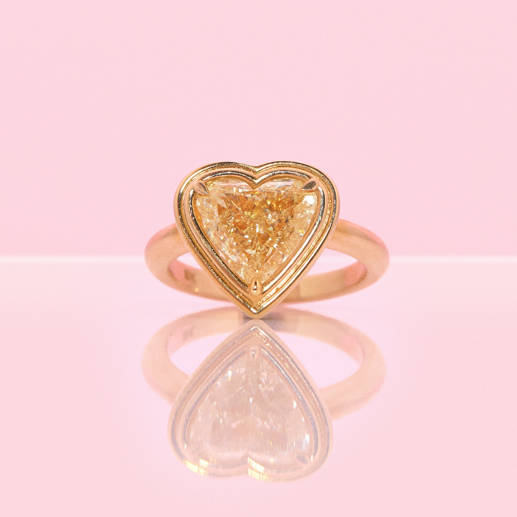 18ct gold bezel set fancy yellow 2.35ct heart-shaped diamond ring