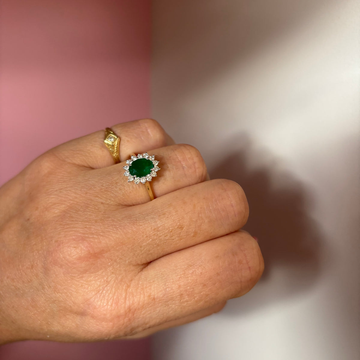 9ct gold 1.10ct oval emerald and 0.32ct diamond cluster ring