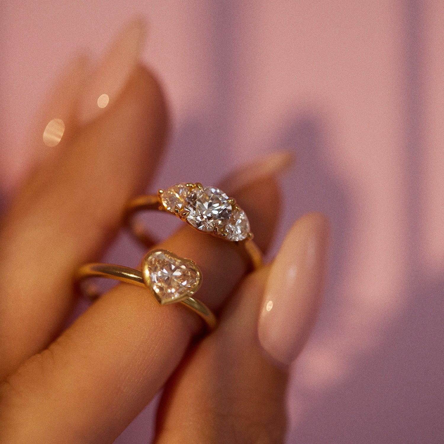 18ct gold ‘Hidden Hearts’ ring with a 0.90ct round shaped diamond centre stone and two heart shaped diamonds