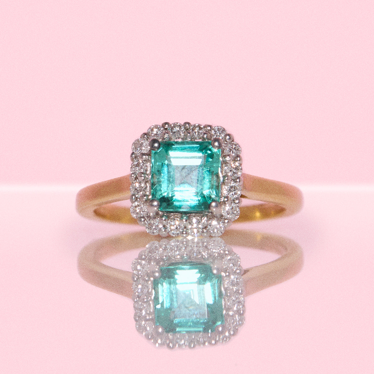 18ct gold 1.10ct emerald and 0.26ct diamond cluster ring