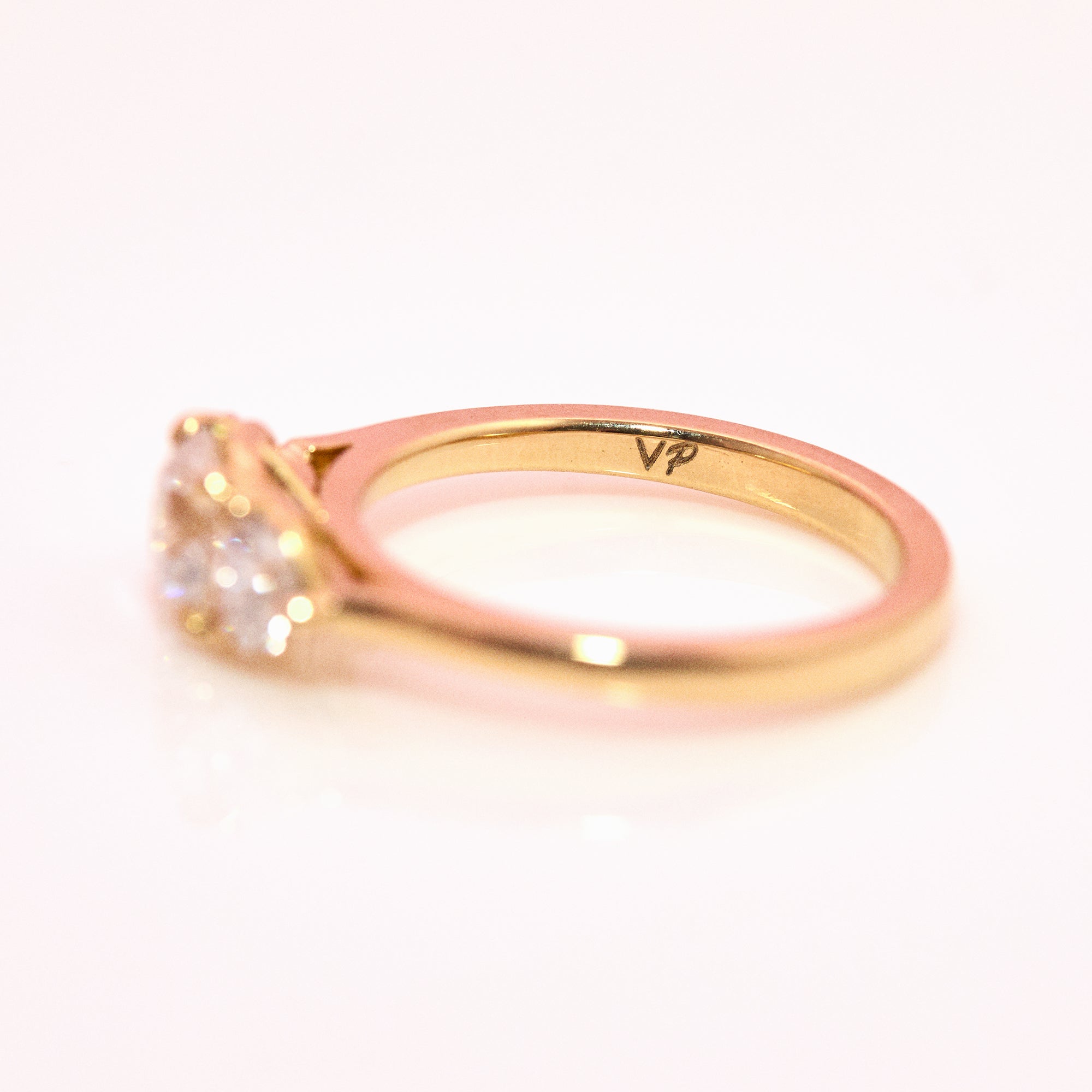 18ct gold ‘Hidden Hearts’ ring with a 0.90ct round shaped diamond centre stone and two heart shaped diamonds