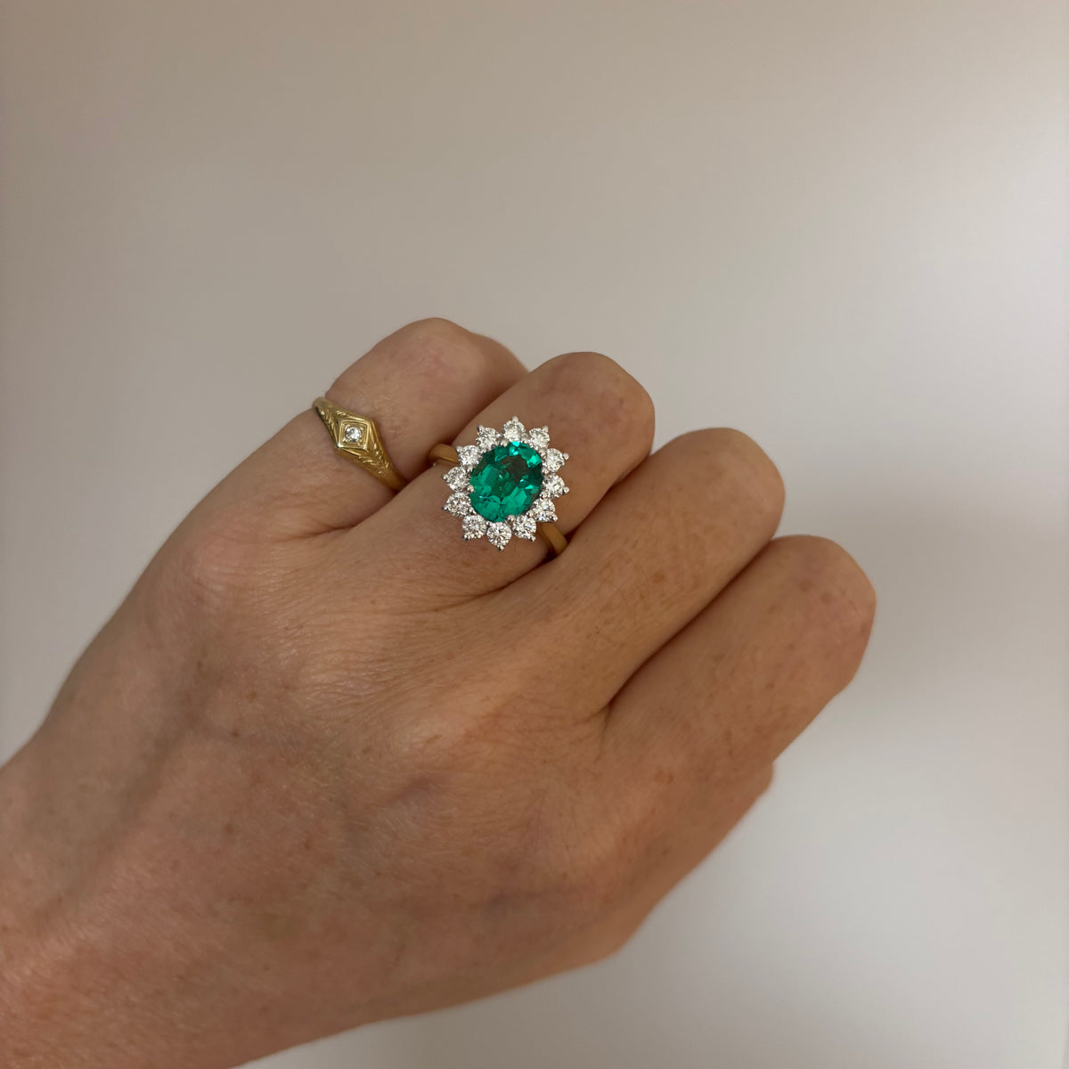 9ct gold 1.93ct oval emerald and 0.88ct diamond cluster ring