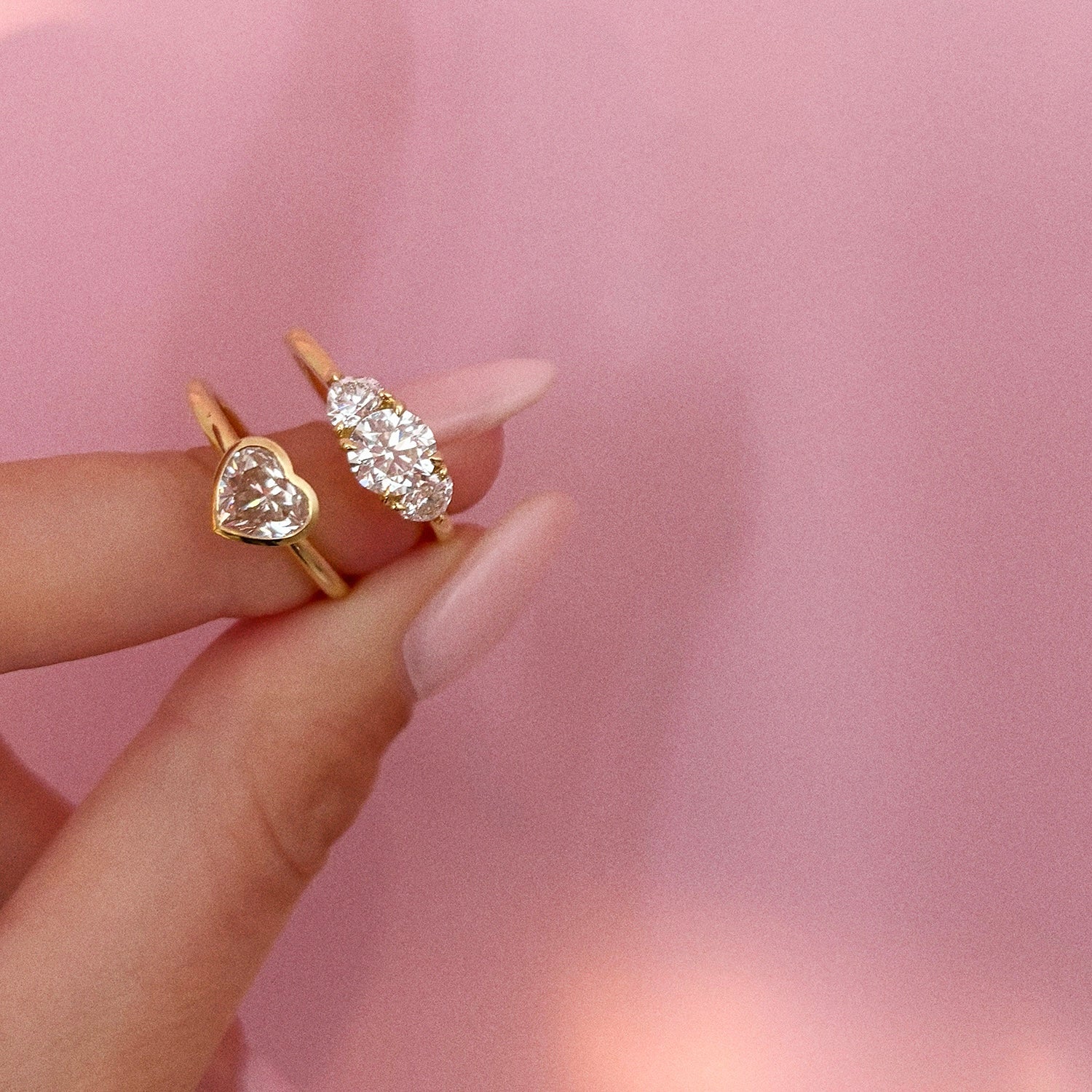 18ct gold ‘Hidden Hearts’ ring with a 0.90ct round shaped diamond centre stone and two heart shaped diamonds
