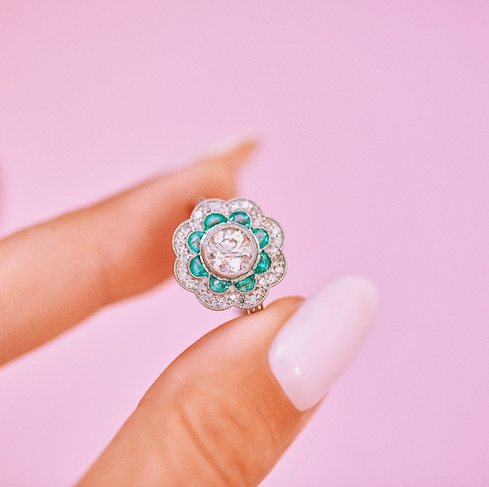 Platinum emerald and diamond flower ring