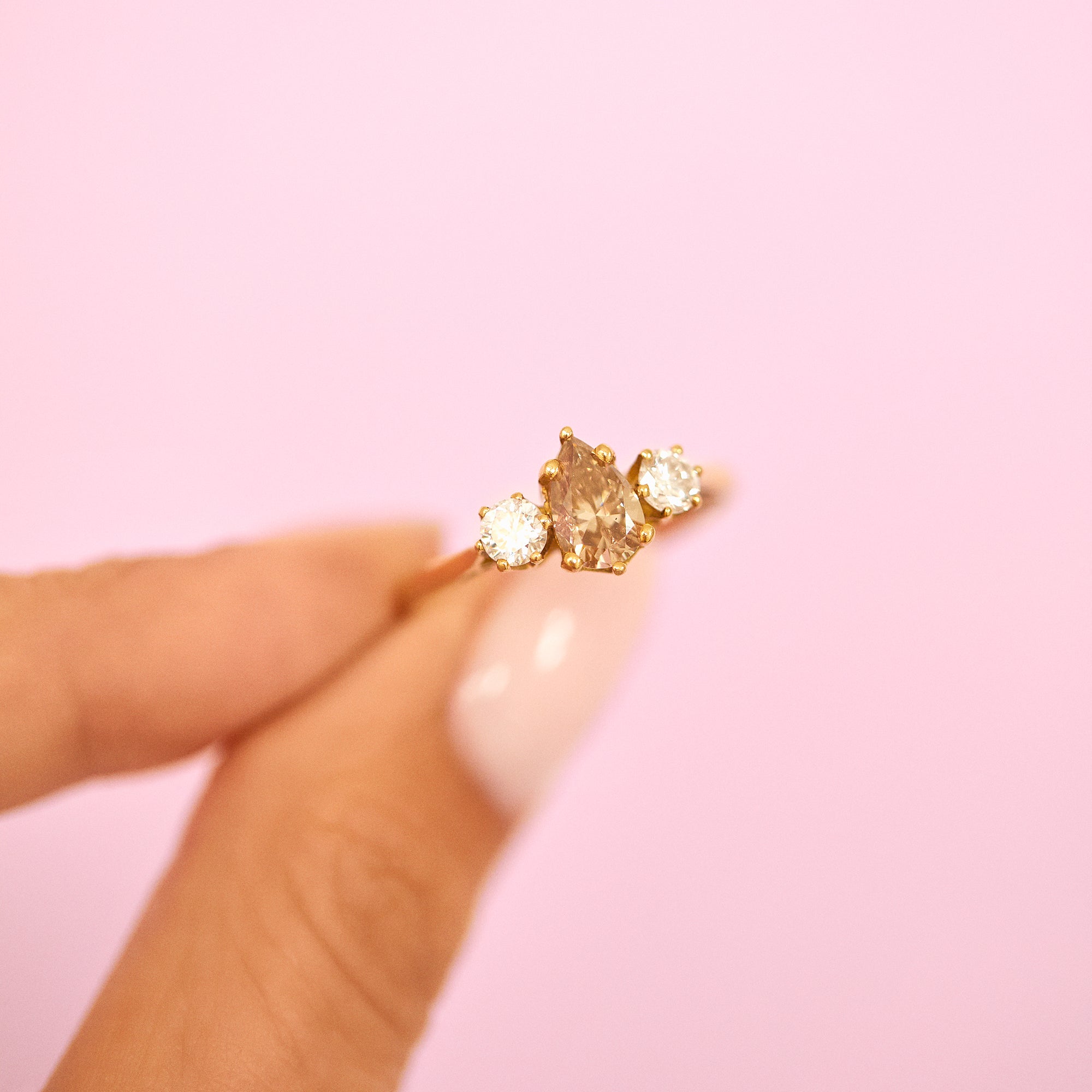 18ct gold three stone ring with a 1.10ct pear shaped yellow diamond centre stone