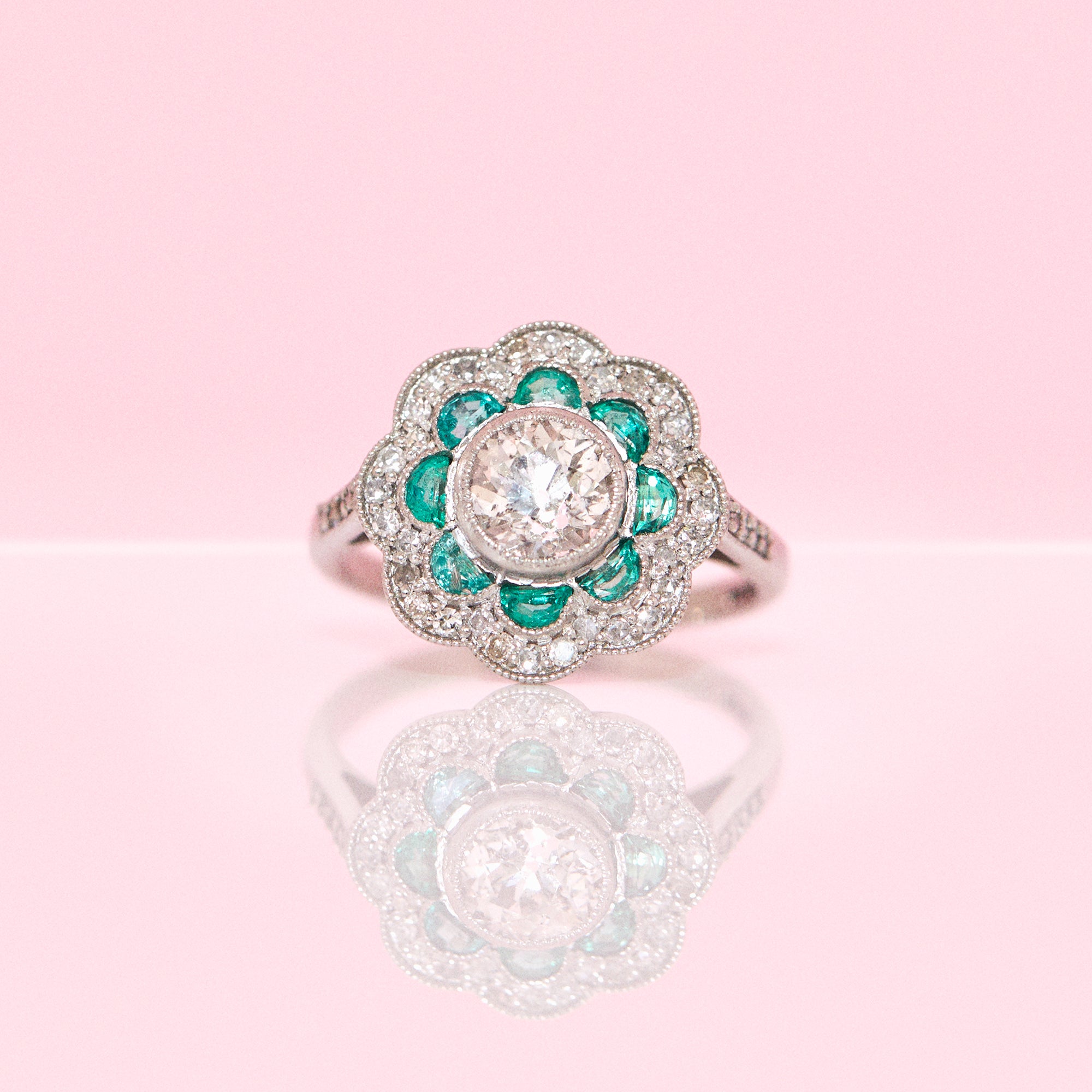 Platinum emerald and diamond flower ring