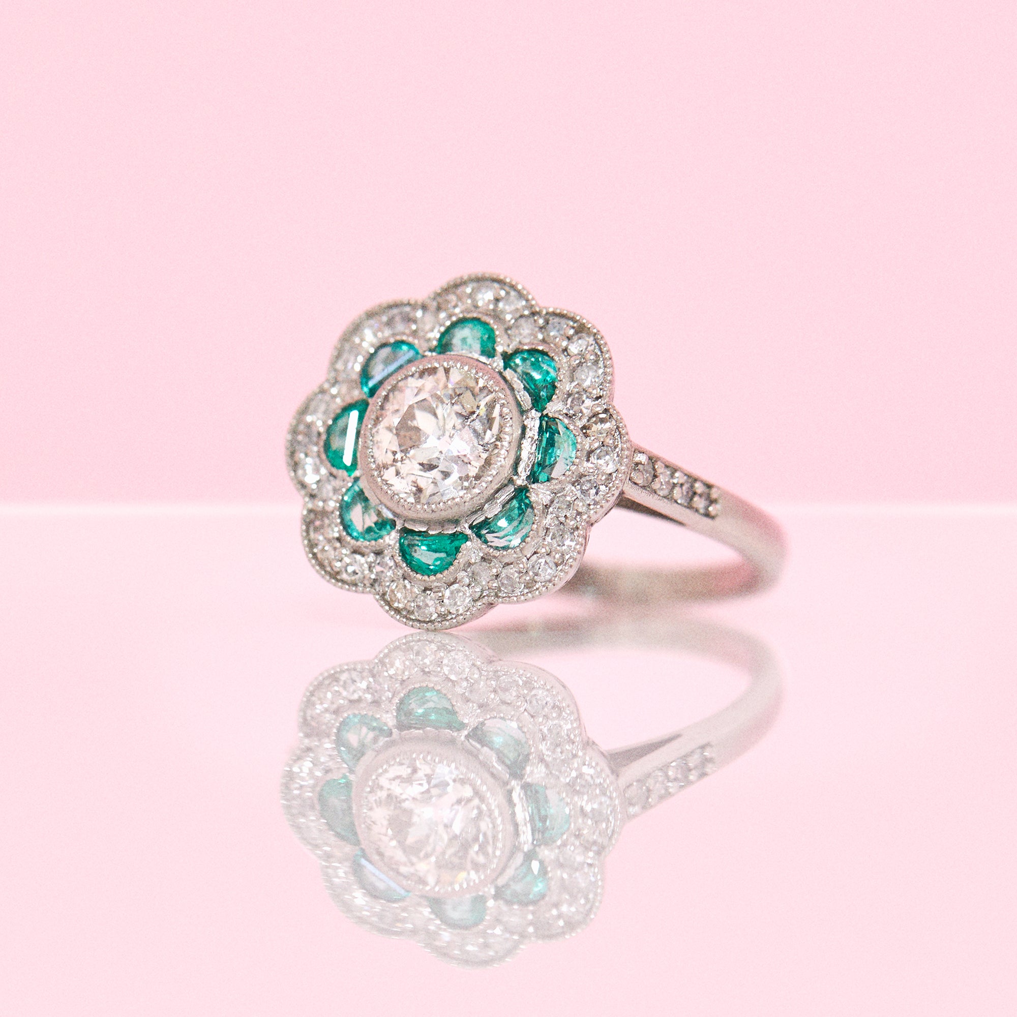 Platinum emerald and diamond flower ring