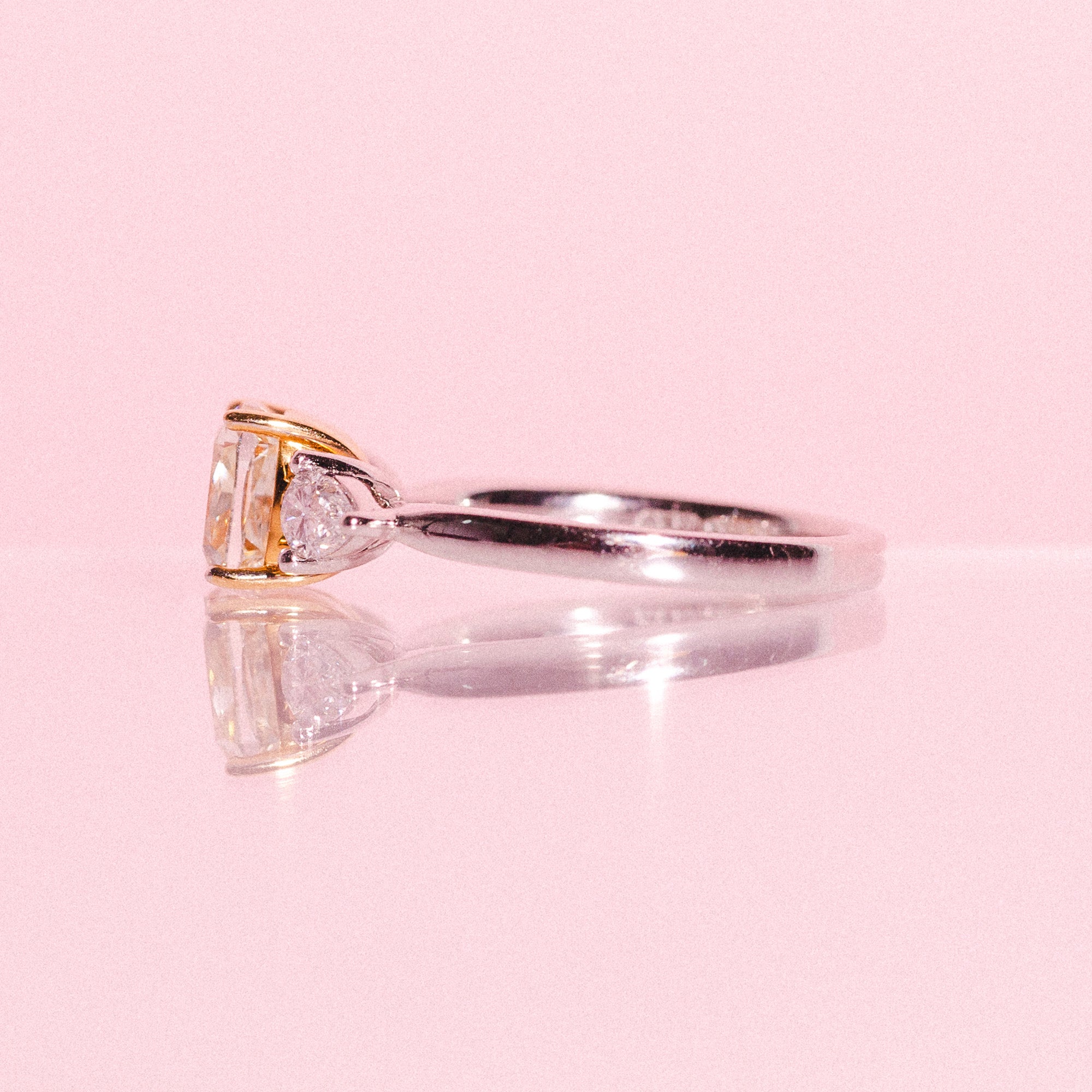 Platinum ring set with one cushion cut yellow diamond and two pear shaped diamonds