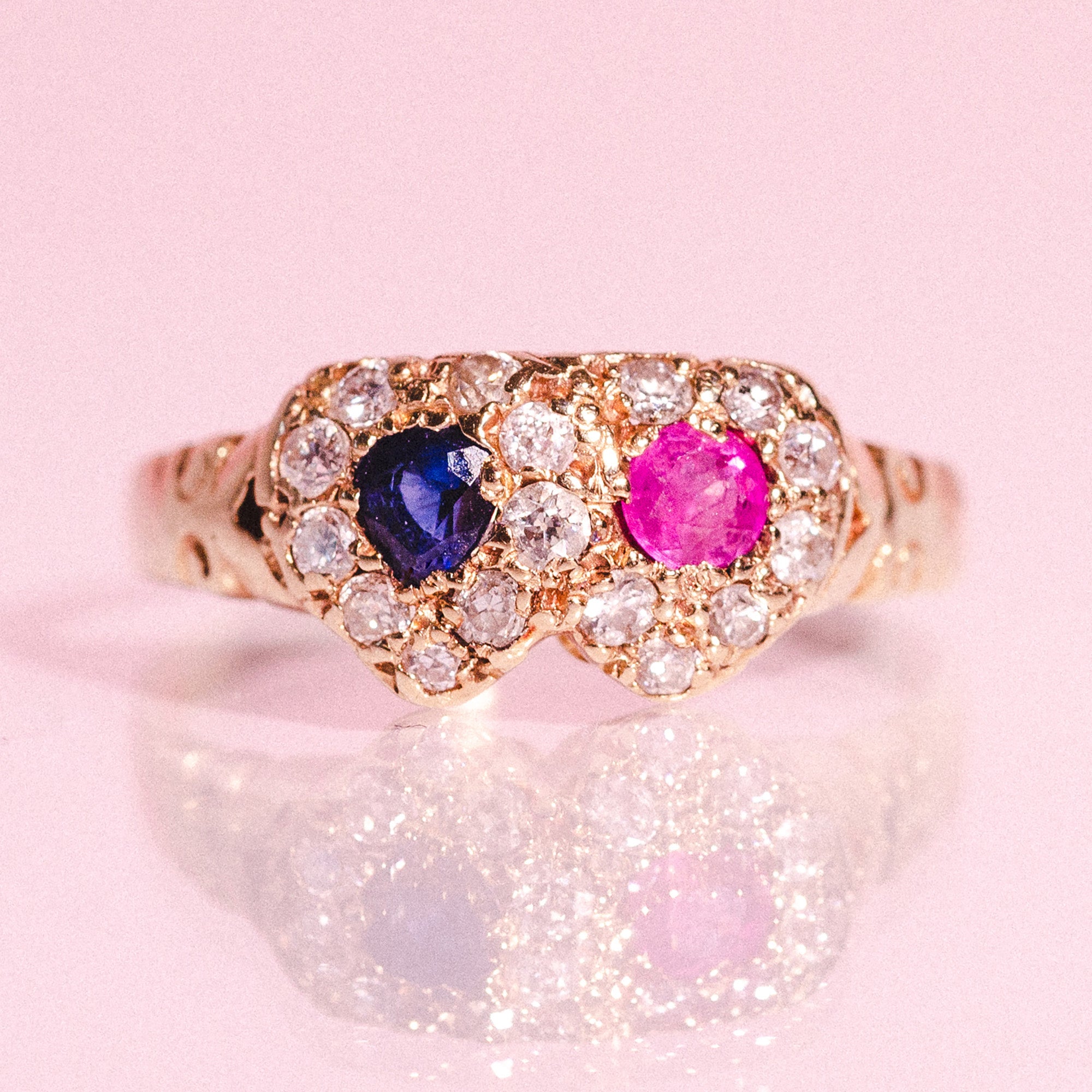 18ct gold love ring set with a ruby, a sapphire and diamonds
