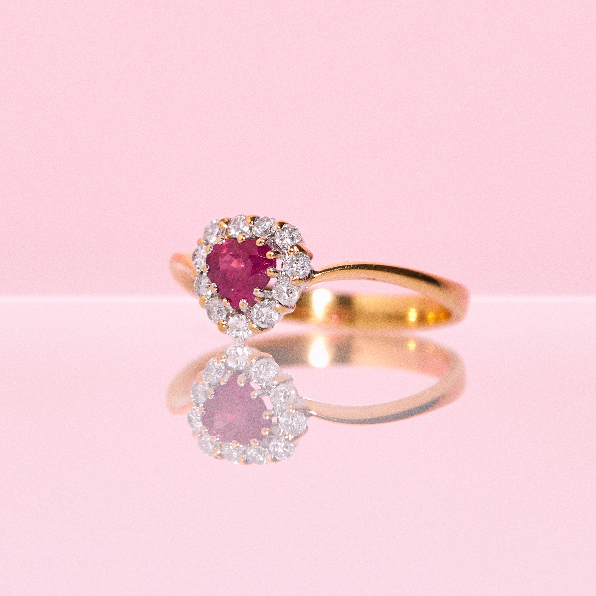 18ct gold ring set with a heart shaped ruby and diamonds
