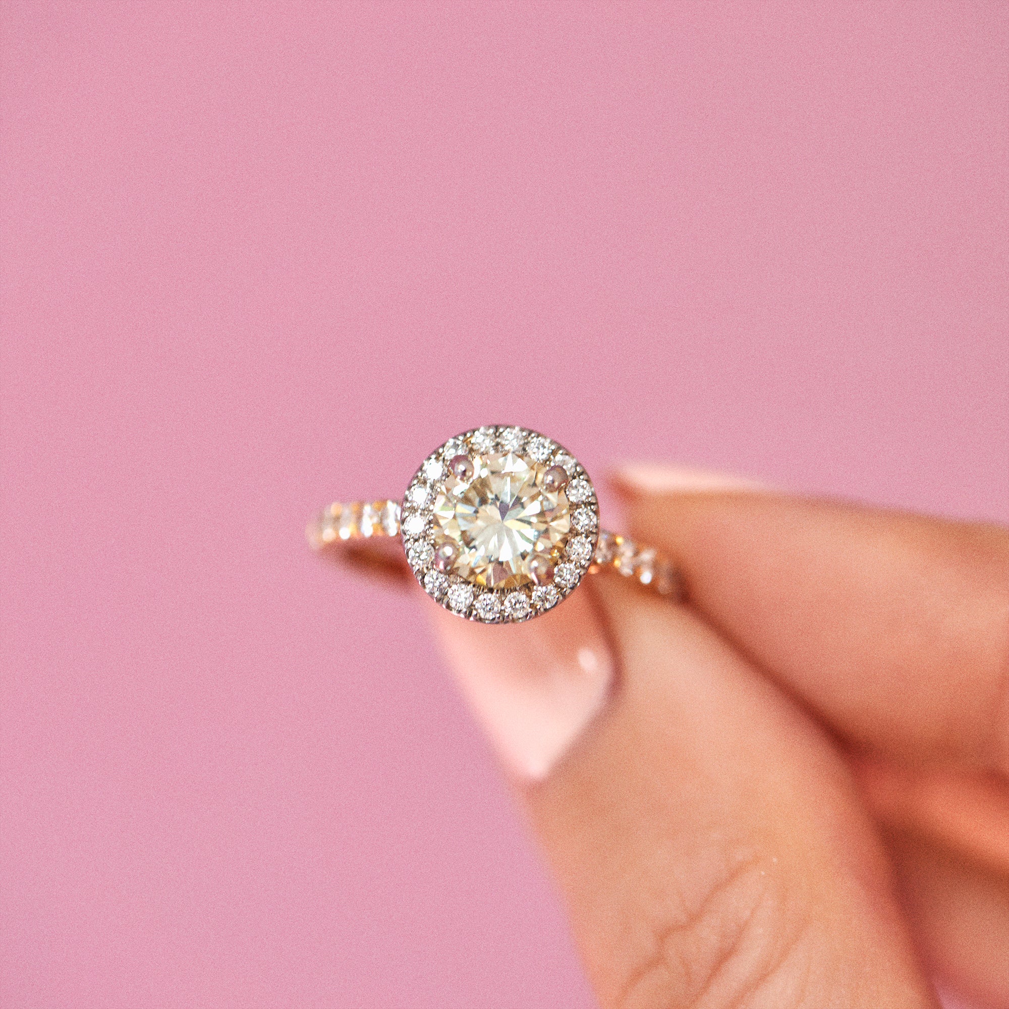 18ct yellow gold yellow diamond ring set with a diamond halo
