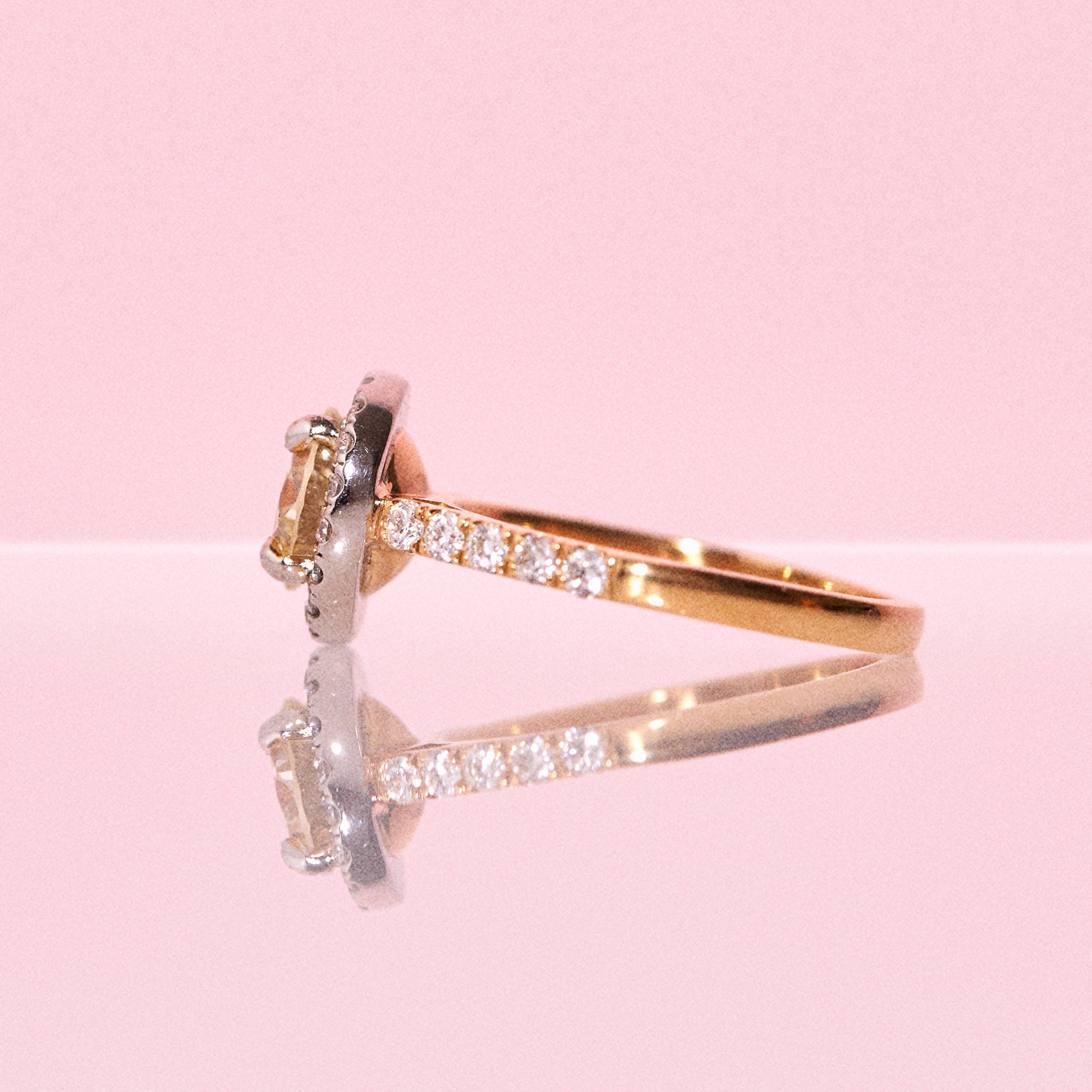 18ct yellow gold yellow diamond ring set with a diamond halo