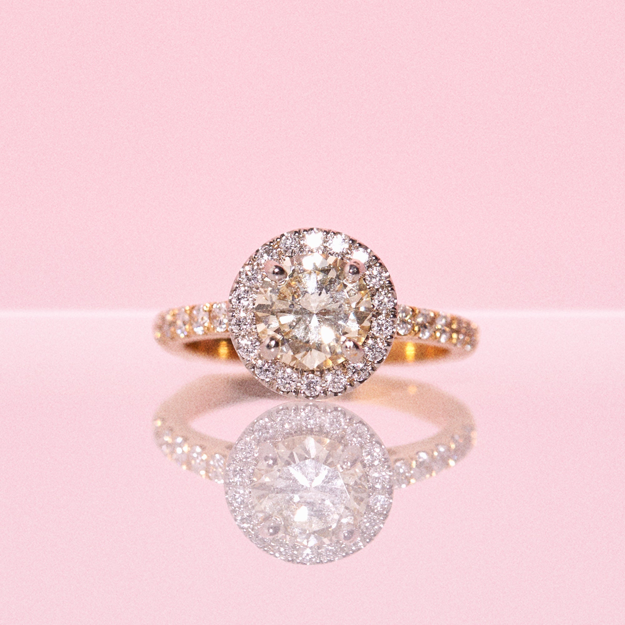18ct yellow gold yellow diamond ring set with a diamond halo