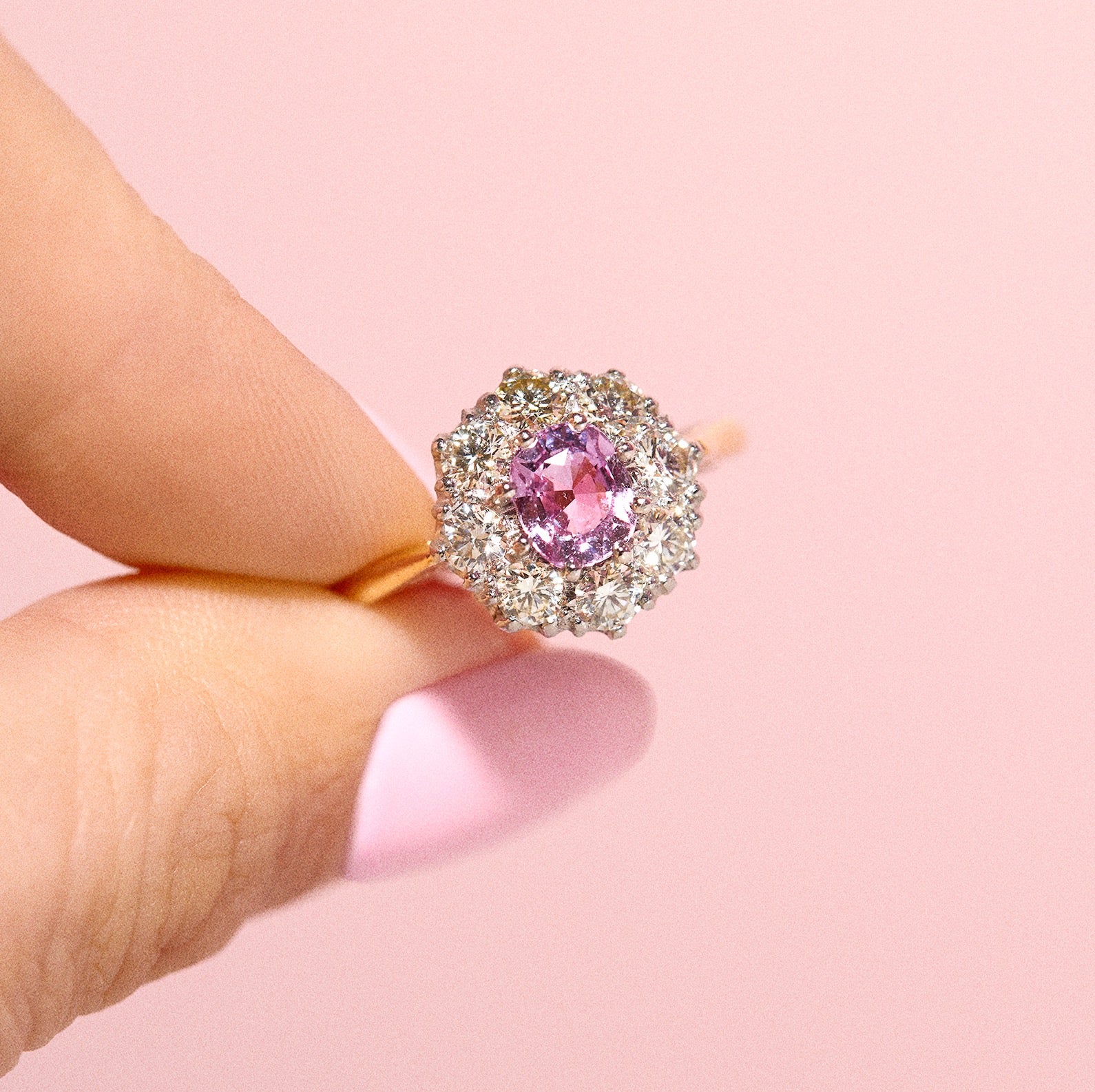 18ct gold ring set with a pink sapphire and diamonds
