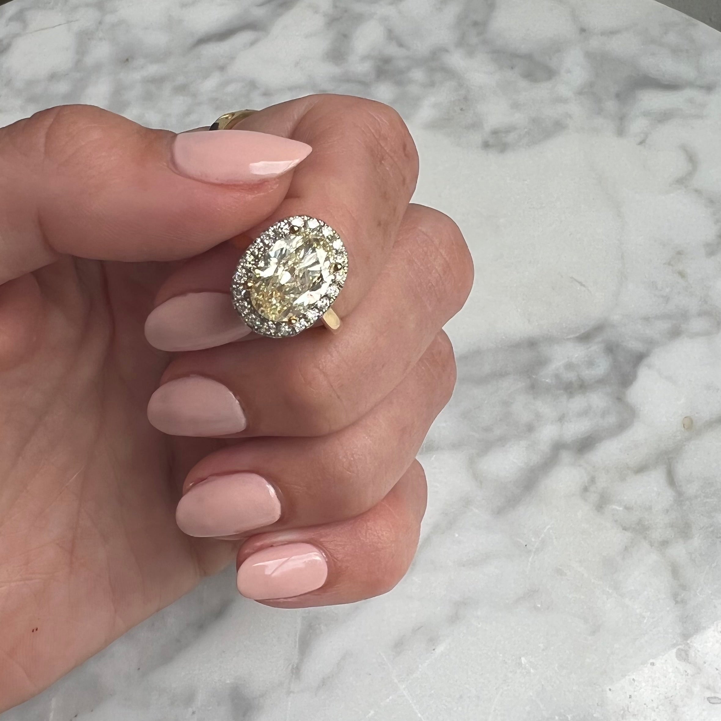 18ct gold yellow diamond ring with a diamond halo