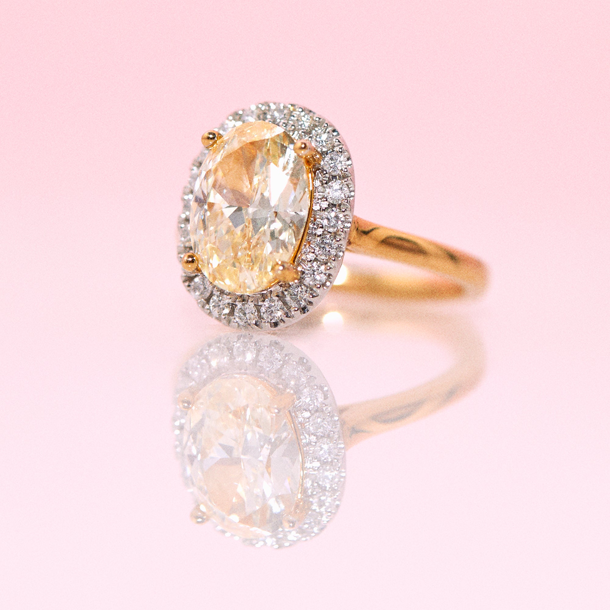 18ct gold yellow diamond ring with a diamond halo