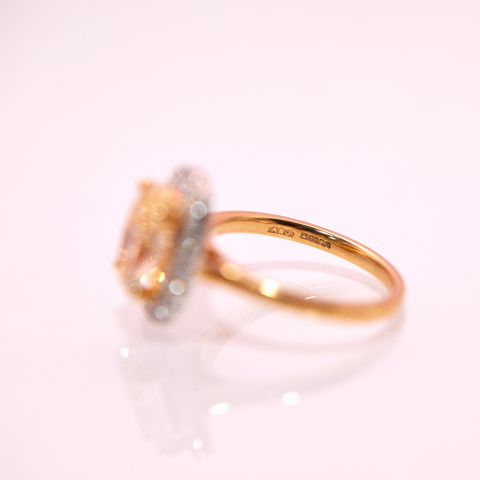 18ct gold yellow diamond ring with a diamond halo