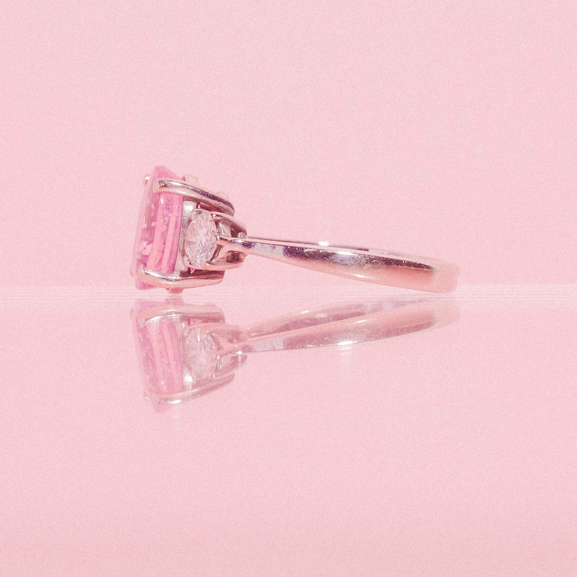 18ct white gold ring set with a pink sapphire and two diamonds