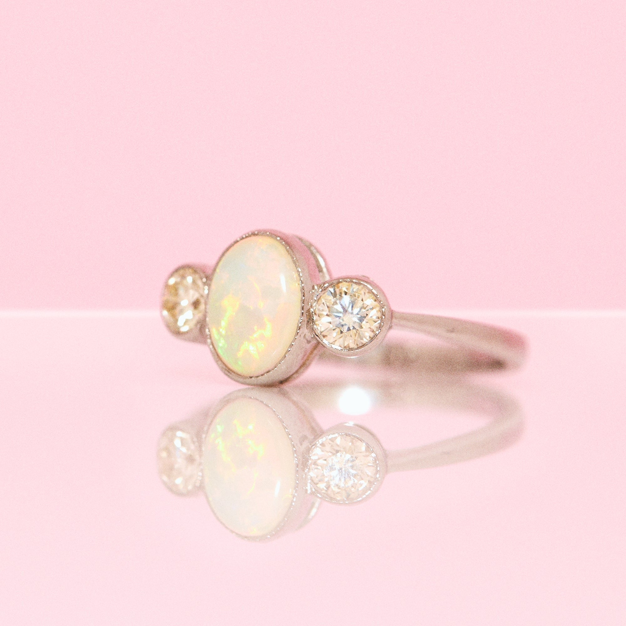 Platinum opal and diamond three stone ring