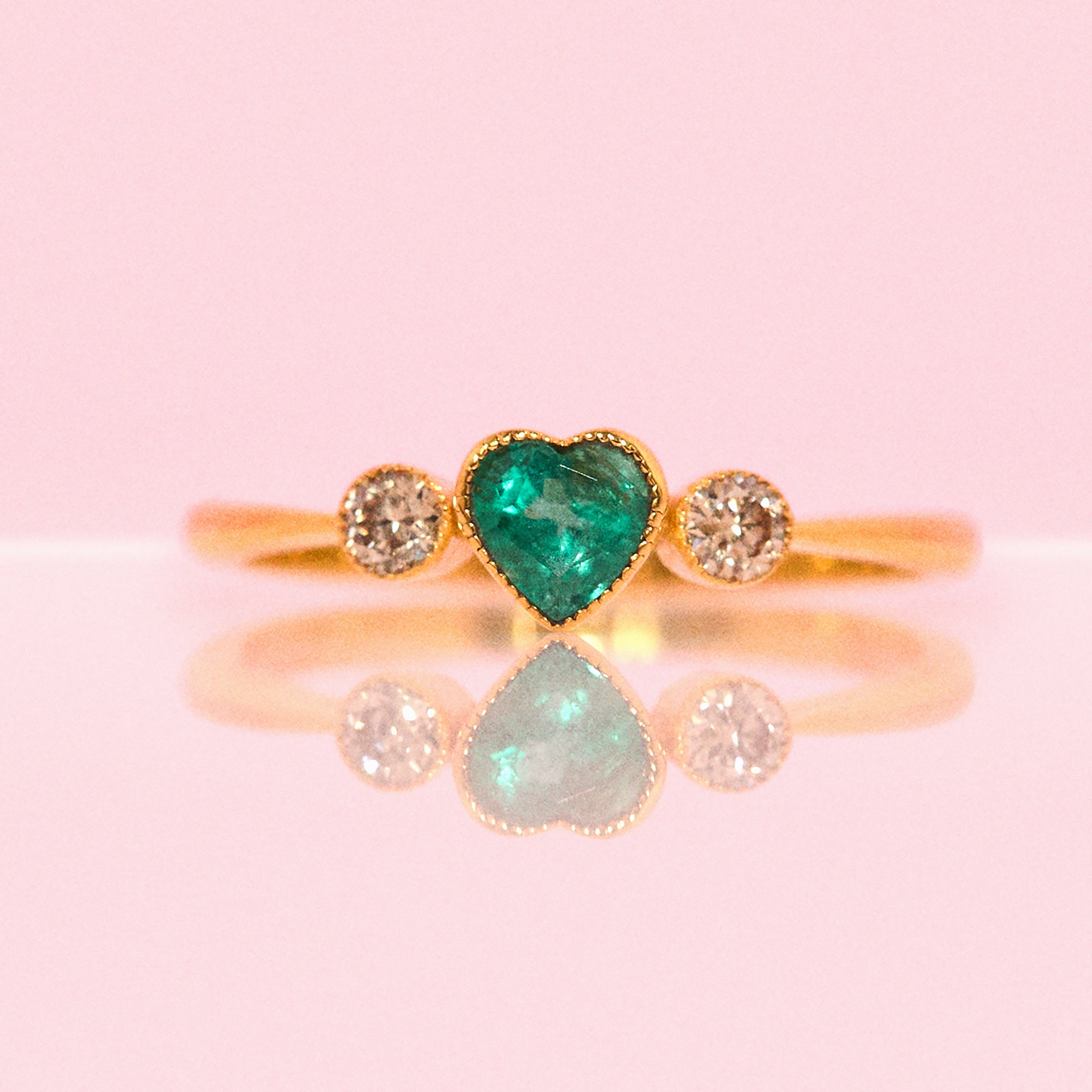 14ct gold heart-shaped emerald and diamond three stone ring