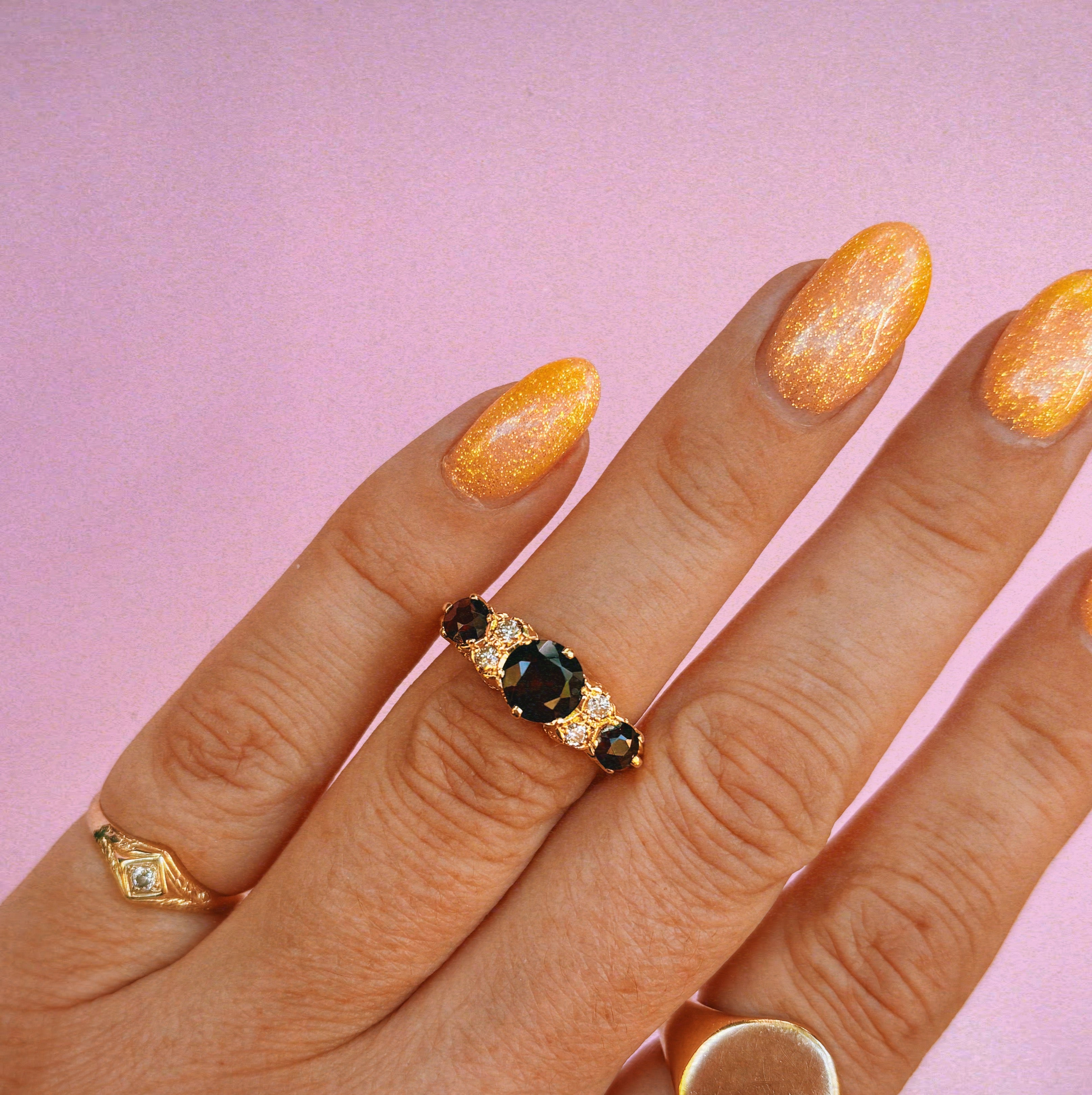 18ct gold garnet and diamond seven stone ring