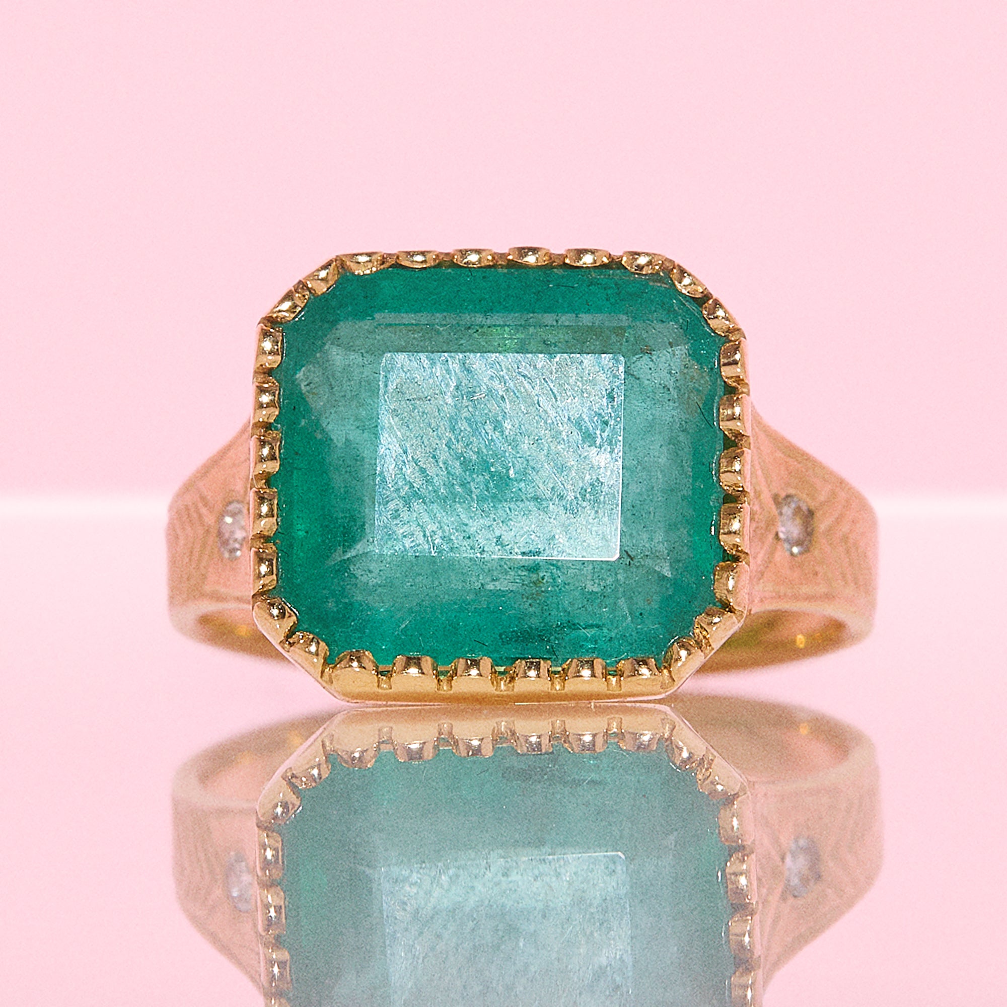 14ct gold 10.80ct Asscher cut emerald and diamond ring with engraved shoulders