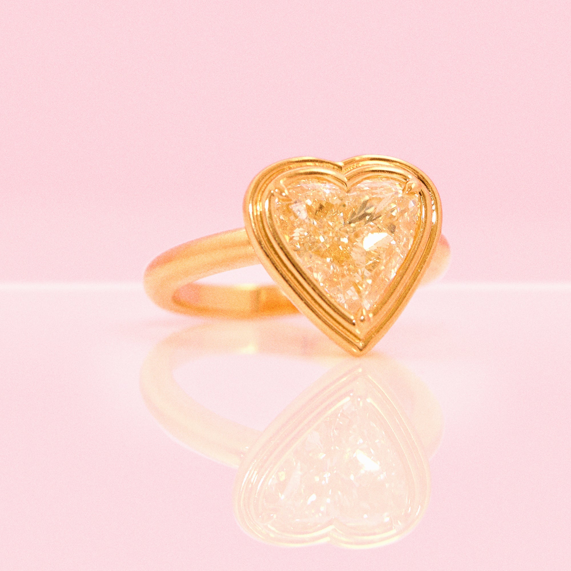 18ct gold bezel set fancy yellow 2.35ct heart-shaped diamond ring