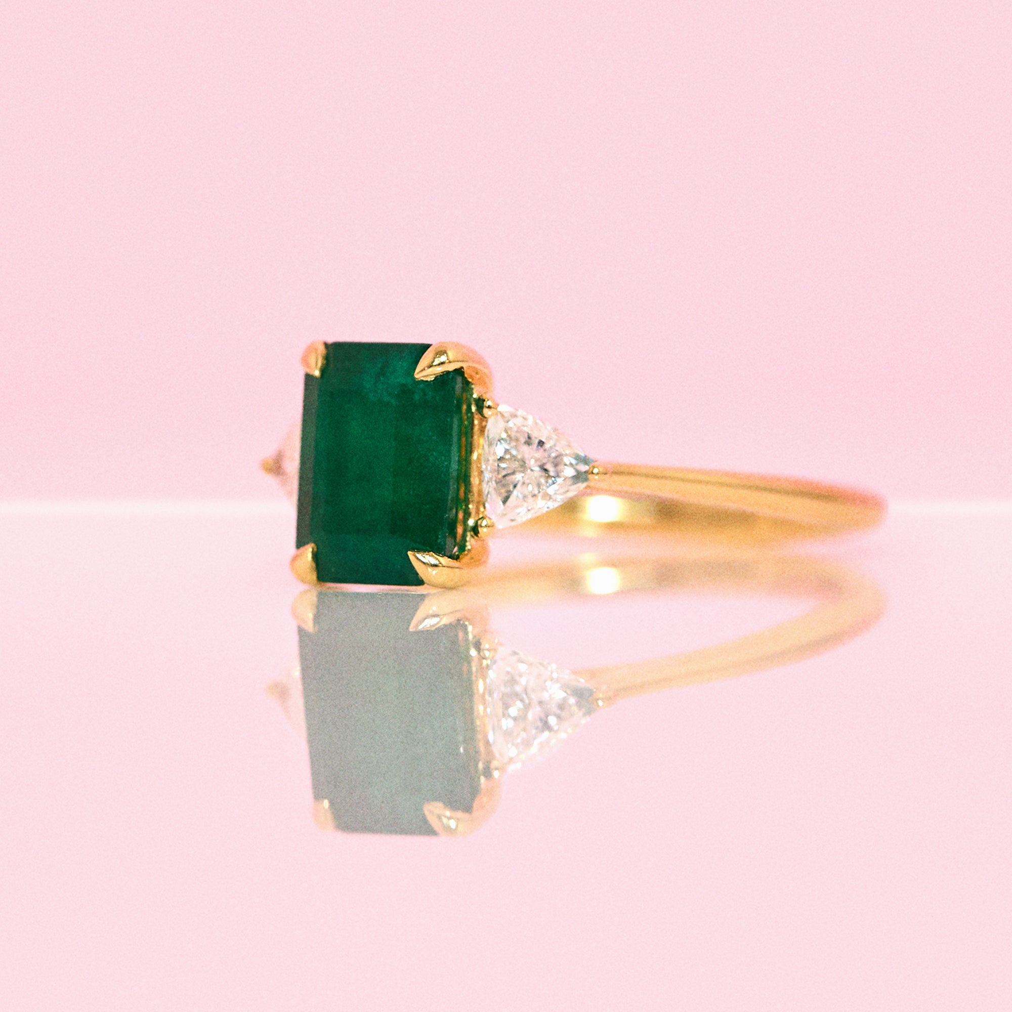 18ct gold emerald and diamond trillion three stone ring