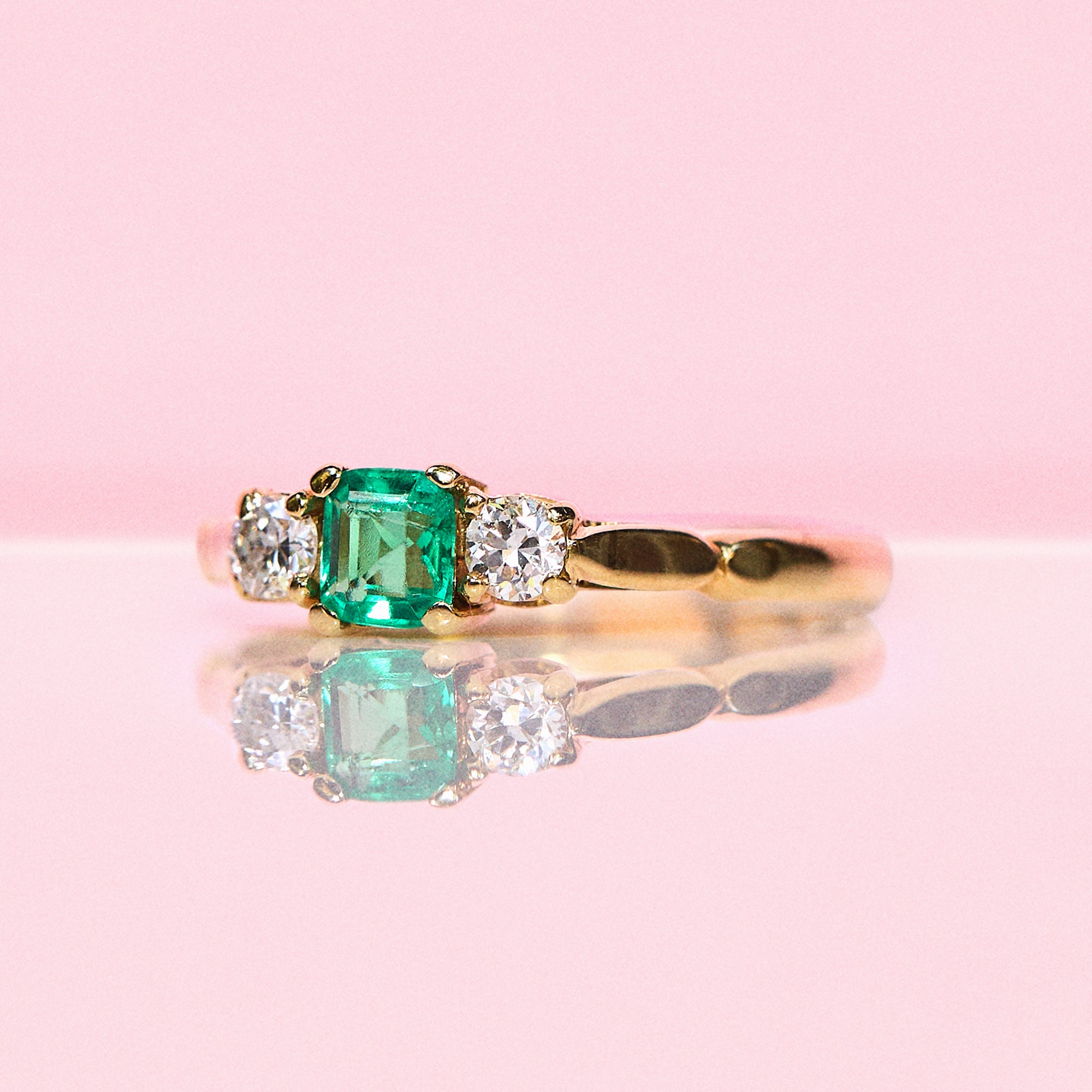 18ct gold emerald cut emerald and diamond three stone ring