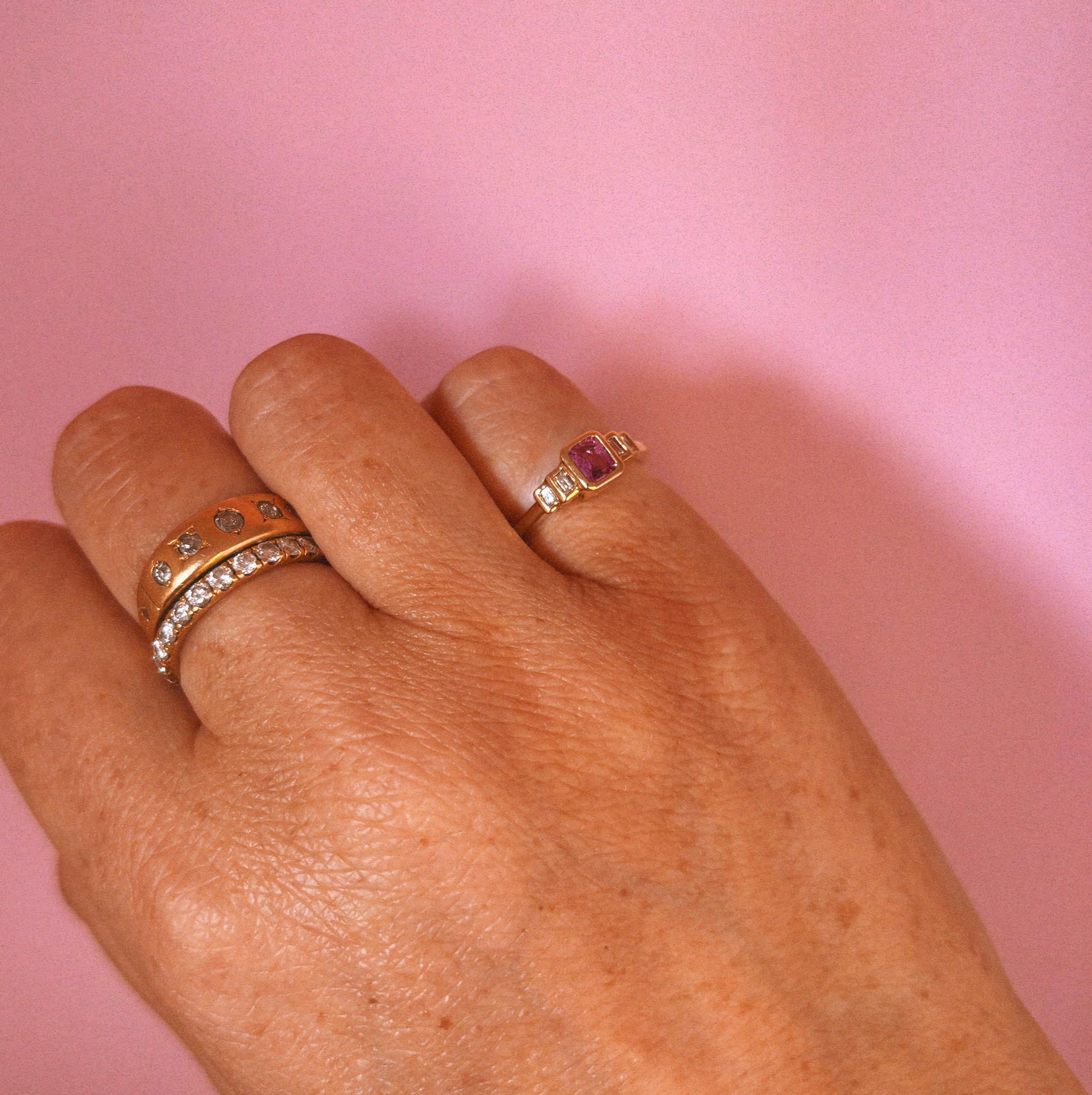 18ct gold 0.52ct emerald cut pink sapphire and baguette diamond three stone ring