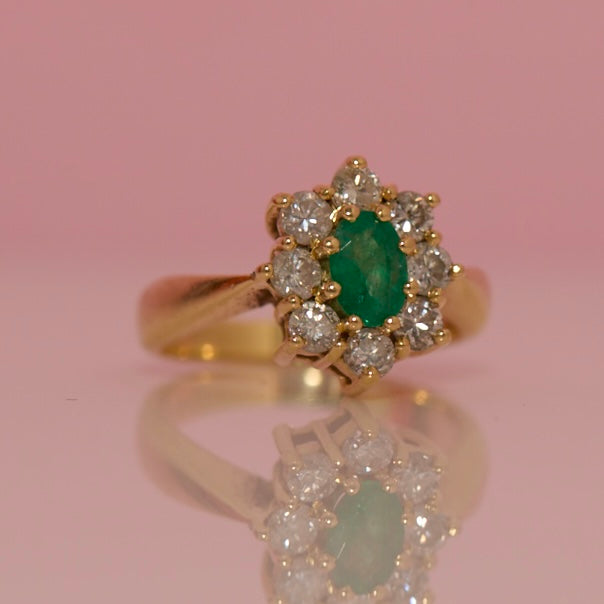 18ct gold emerald and diamond cluster ring with a graduated band