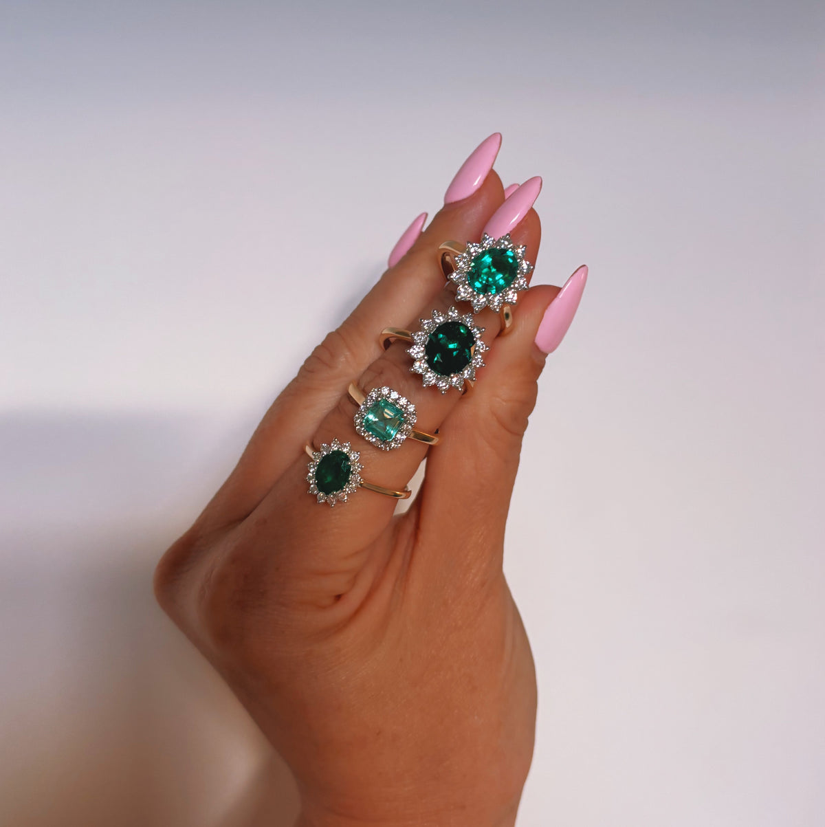 9ct gold 1.10ct oval emerald and 0.32ct diamond cluster ring